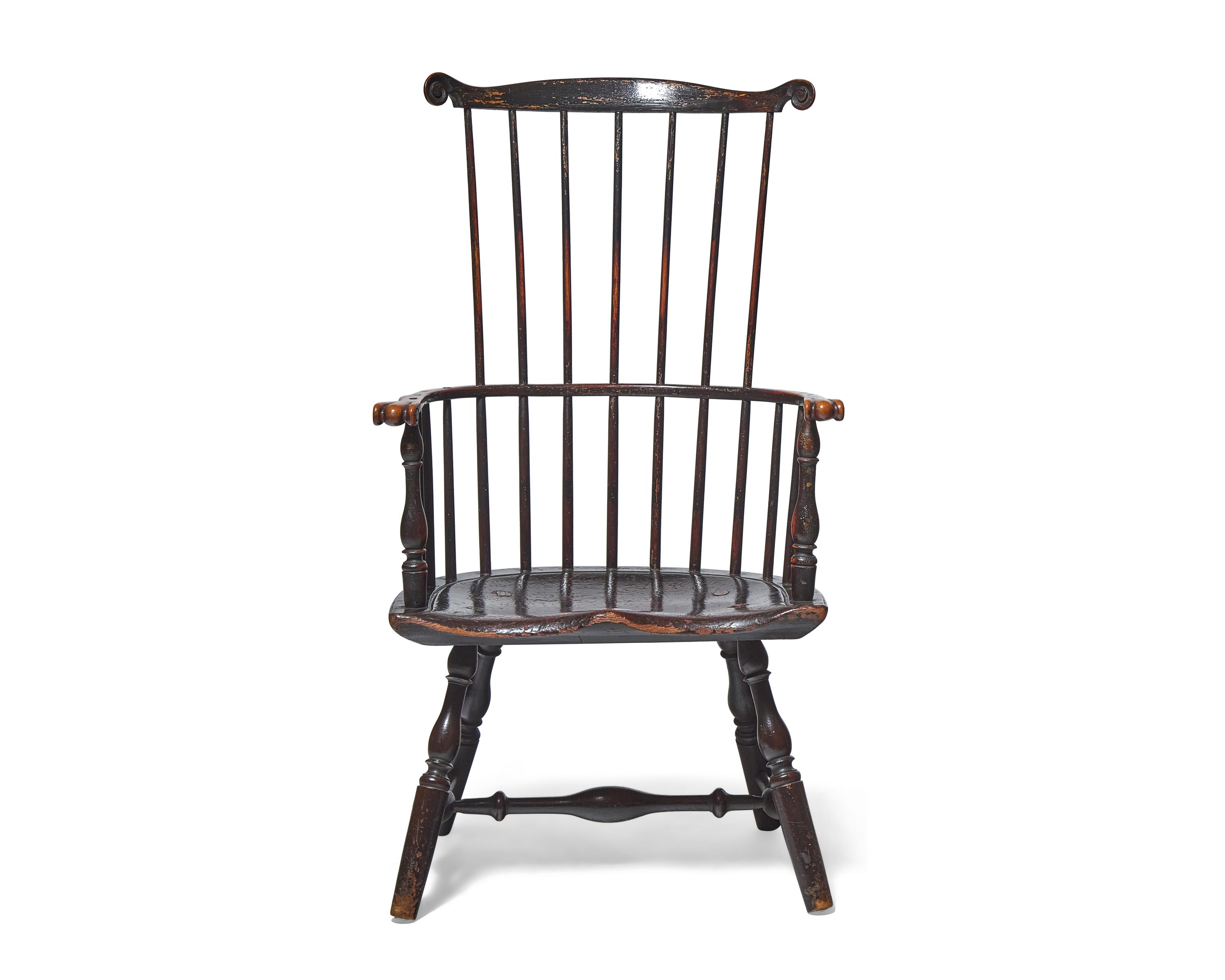A Turned and Black-Painted Comb-Back Windsor Armchair