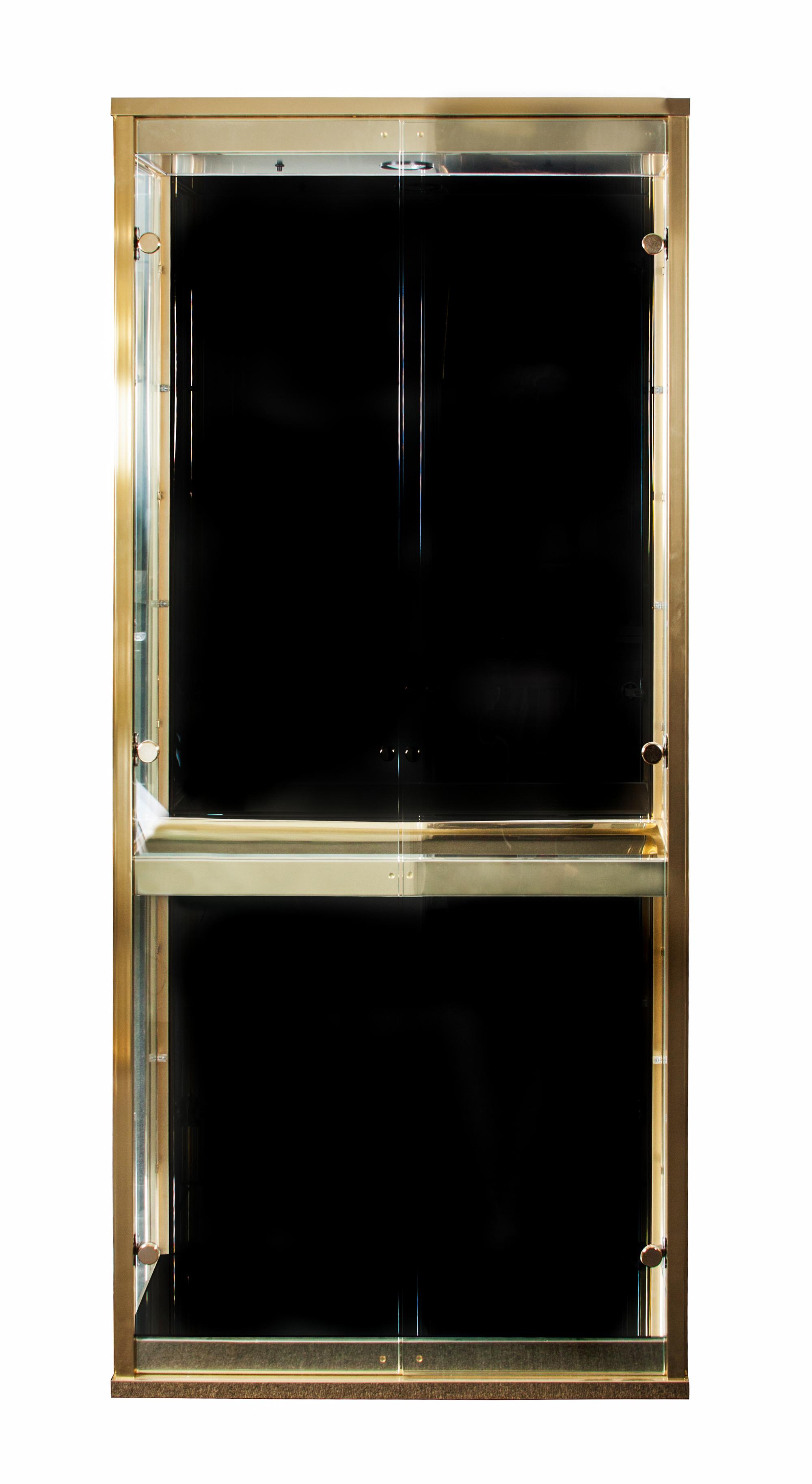 A Brass and Glass Vitrine Height 74 1/4 x width 33 x depth 13 1/2 inches. — SECOND HALF OF 20TH CENTURY
