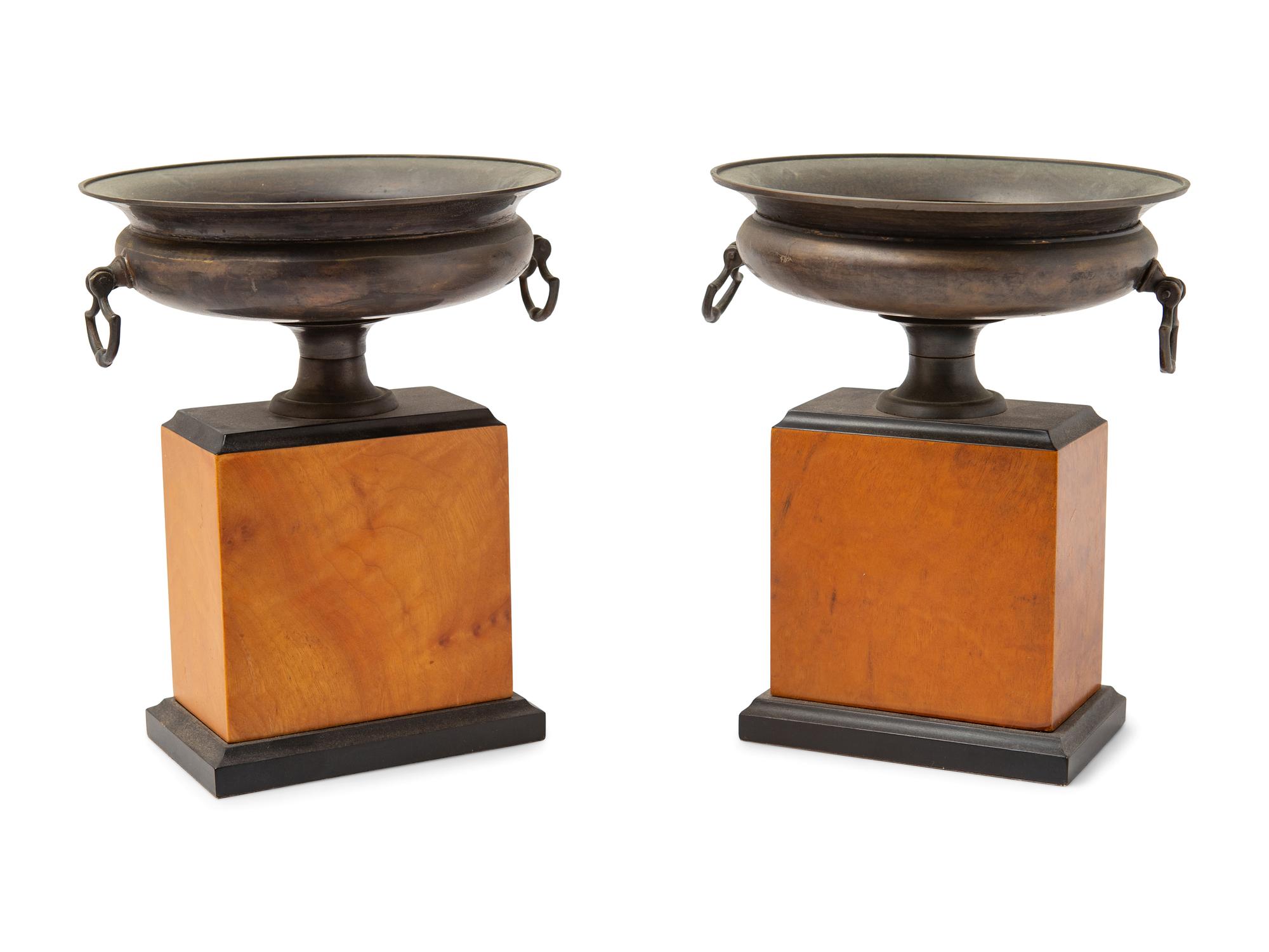A Pair of Grand Tour Style Cast Metal Urns on Plinths