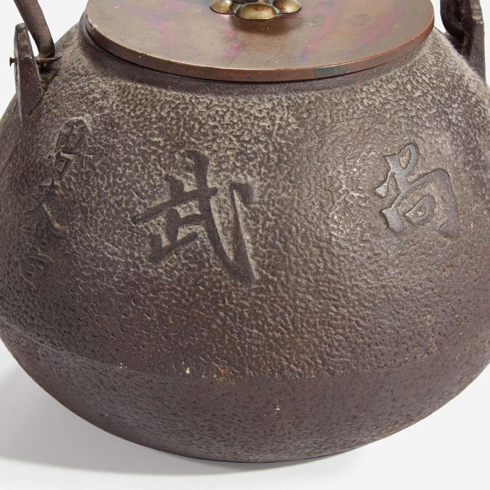 Two Japanese iron tetsubin with patinated bronze covers