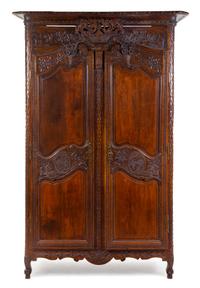 A French Provincial Carved Walnut Armoire Height 87 3/4 x width 51 x depth 19 1/2 inches. — PROBABLY BRITTANY, EARLY 19TH CENTURY