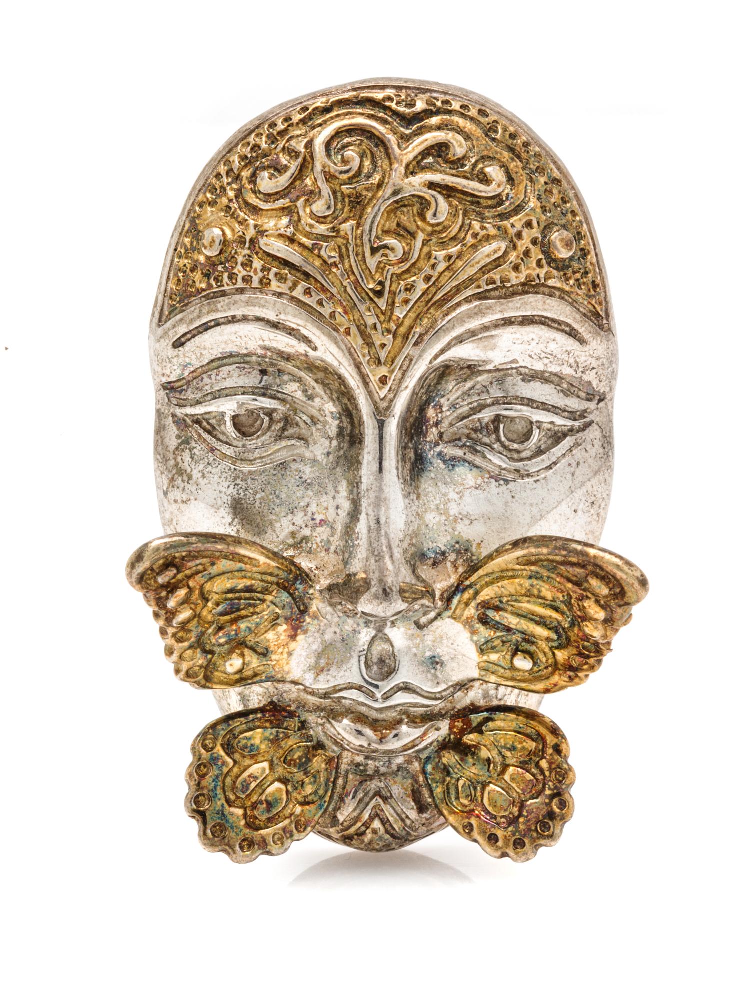A Sterling Silver and Yellow Gold Face and Butterfly Motif Pendant/Brooch, Sergio Bustamante, 18.70 dwts.