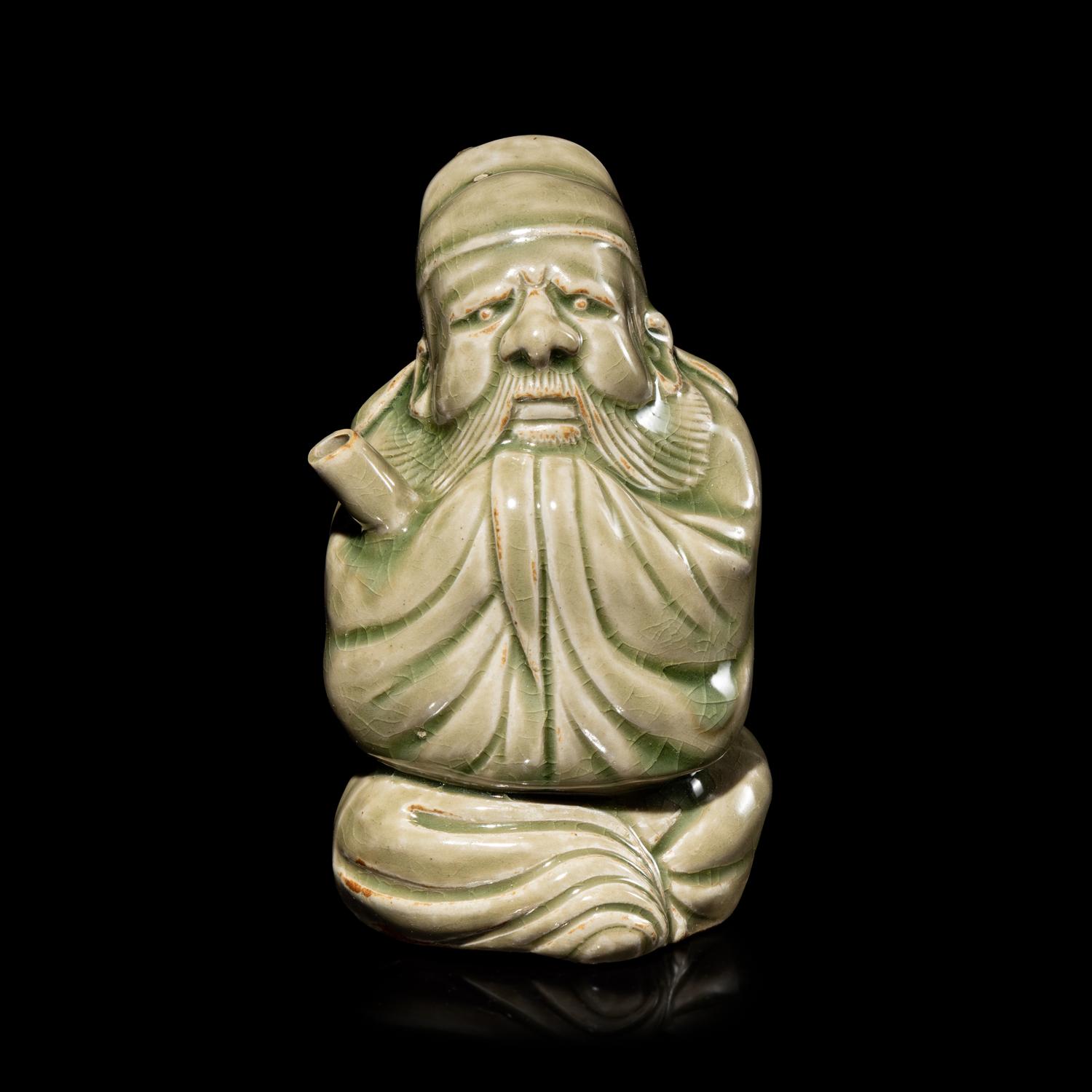 A Chinese Celadon Glazed Porcelain Figure Water Dropper, Yandi — 青釉人物形硯滴