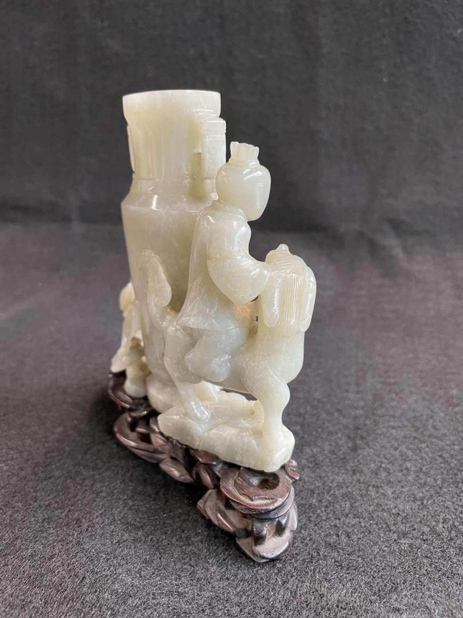 A Chinese jade "Boys, Kylin and Phoenix" vase on carved wood stand 玉雕童子凤鸟花樽及底座