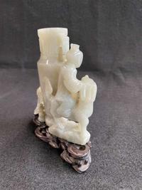 A Chinese jade "Boys, Kylin and Phoenix" vase on carved wood stand 玉雕童子凤鸟花樽及底座