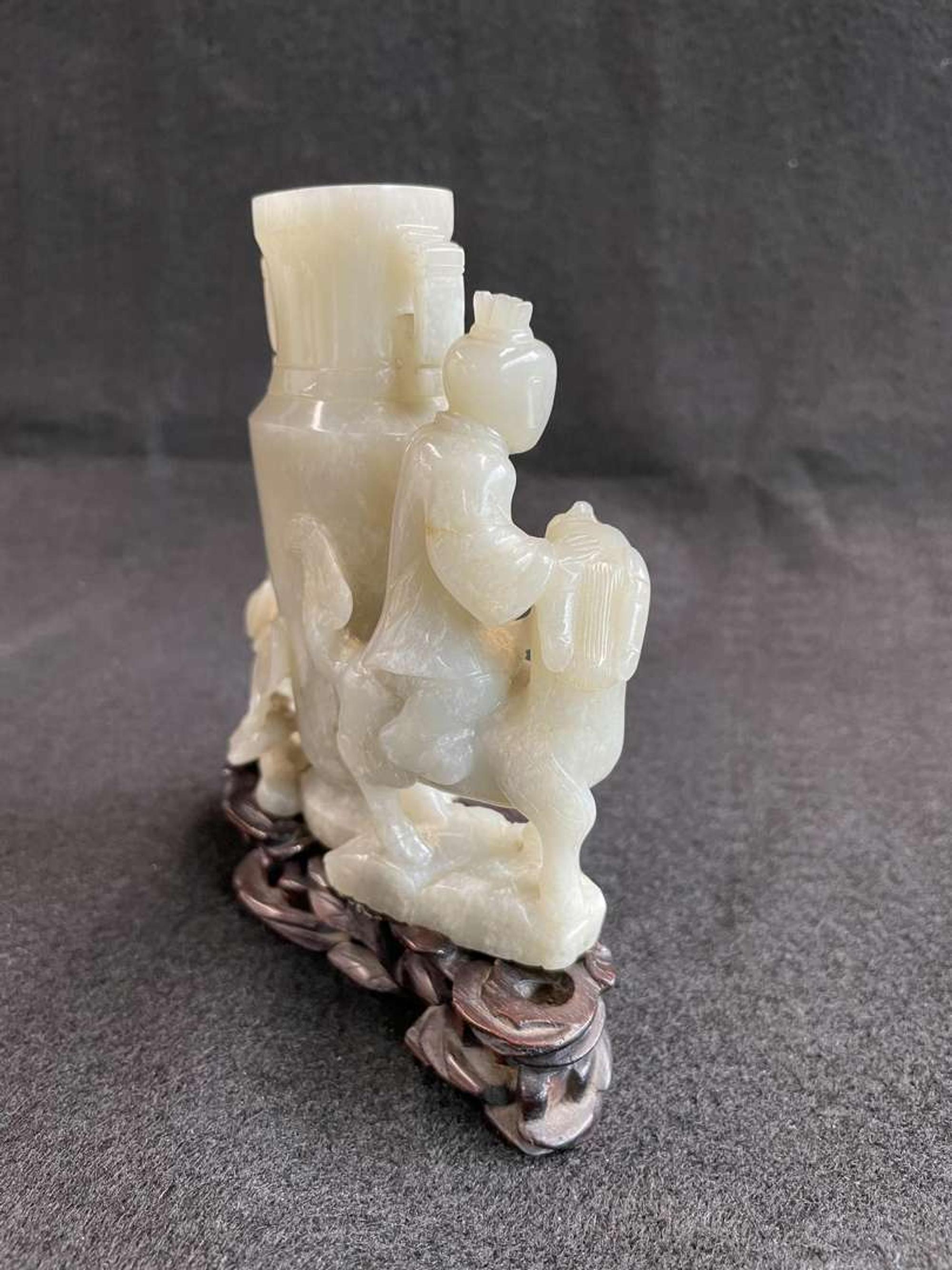 A Chinese jade "Boys, Kylin and Phoenix" vase on carved wood stand 玉雕童子凤鸟花樽及底座