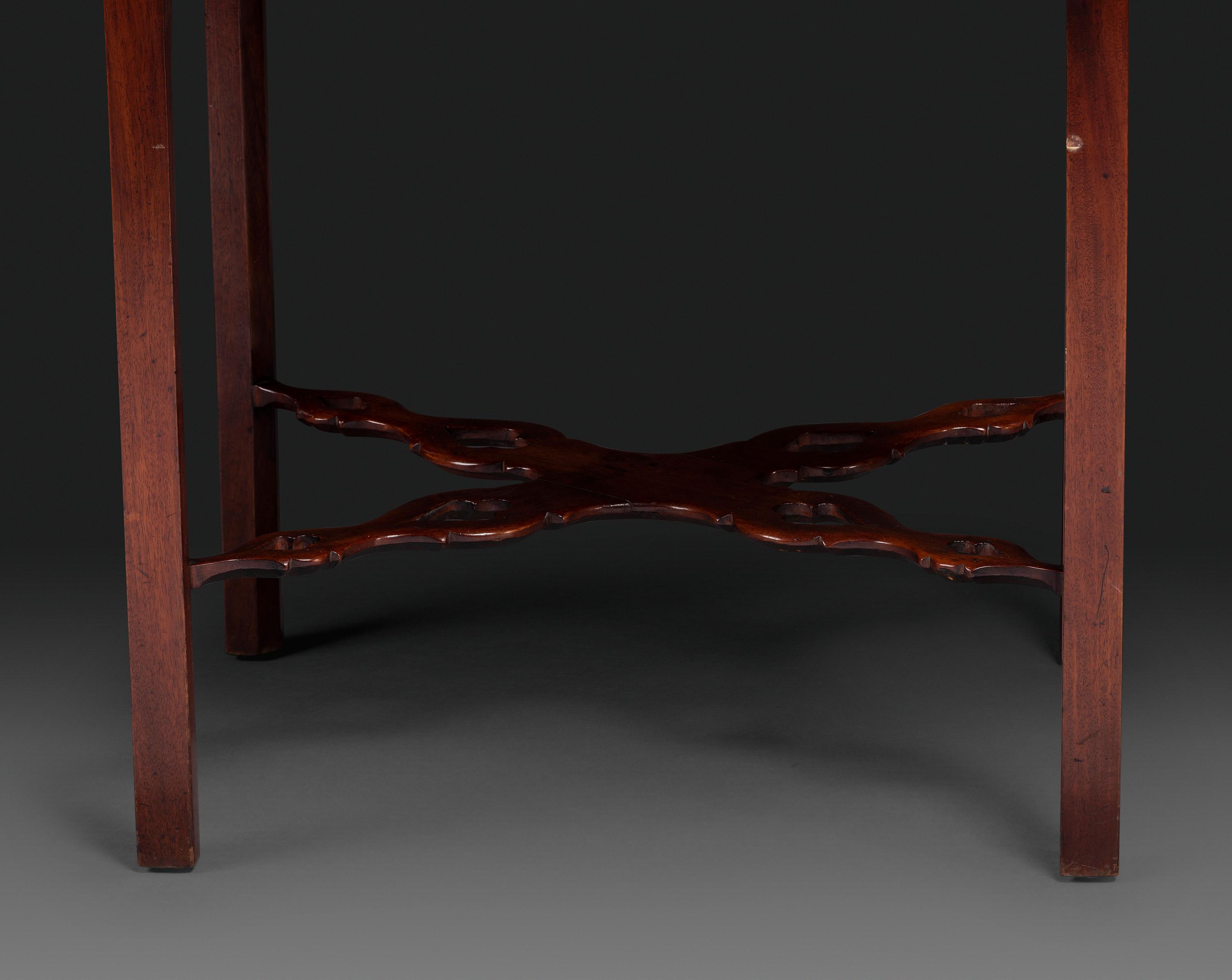 A Late Chippendale Carved and Figured Mahogany Stretcher-Base Pembroke Table
