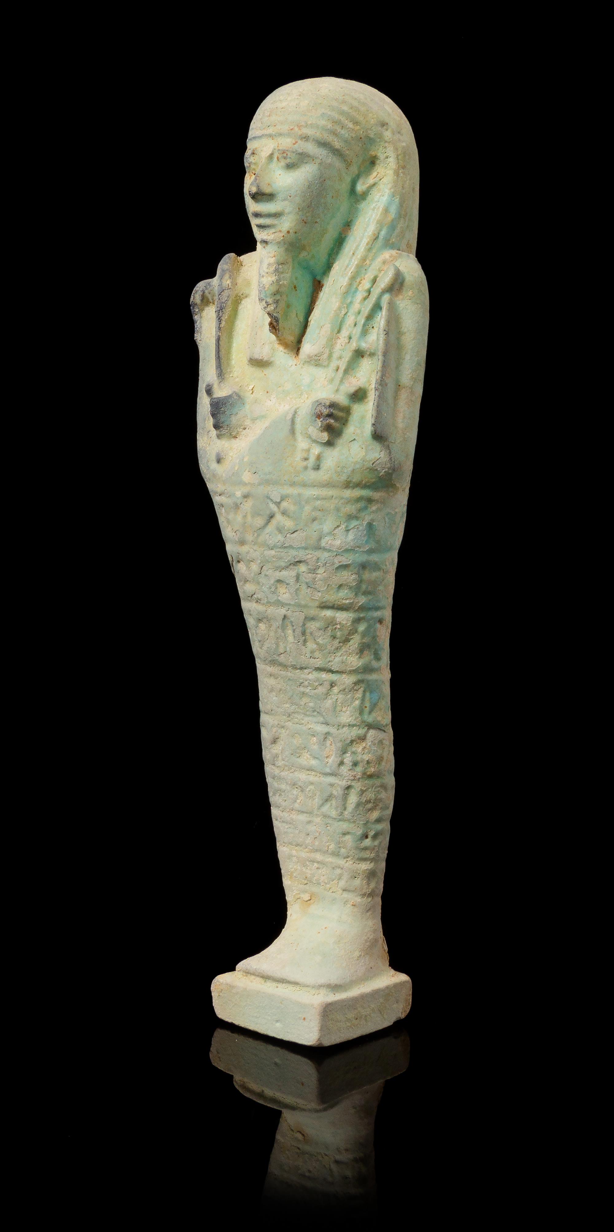 An Egyptian Faience Shabti Height 9 1/2 inches. — LATE PERIOD, DYNASTY 26, 664-525 B.C.E.