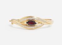 A 14K Yellow Gold and Garnet Bangle Bracelet