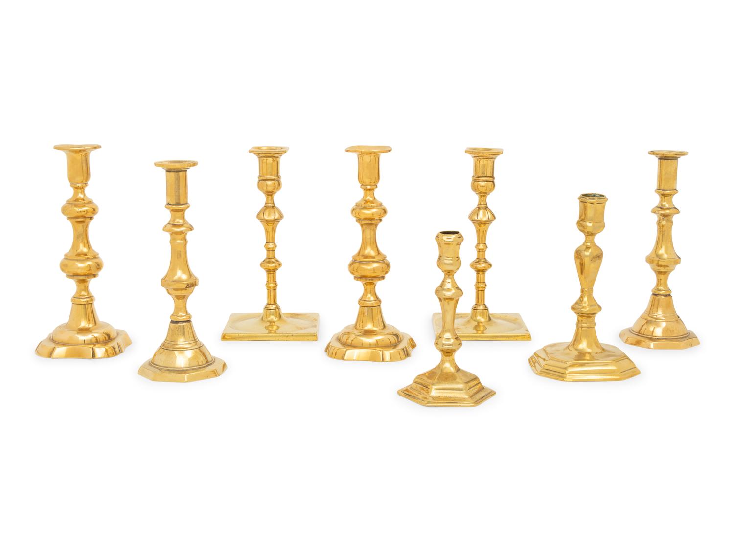 A Group of Eight English Brass Candlesticks