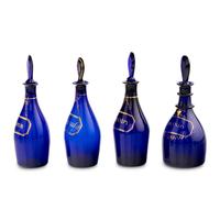 A Group of Four Cobalt Glass and Gilt Decorated Decanters