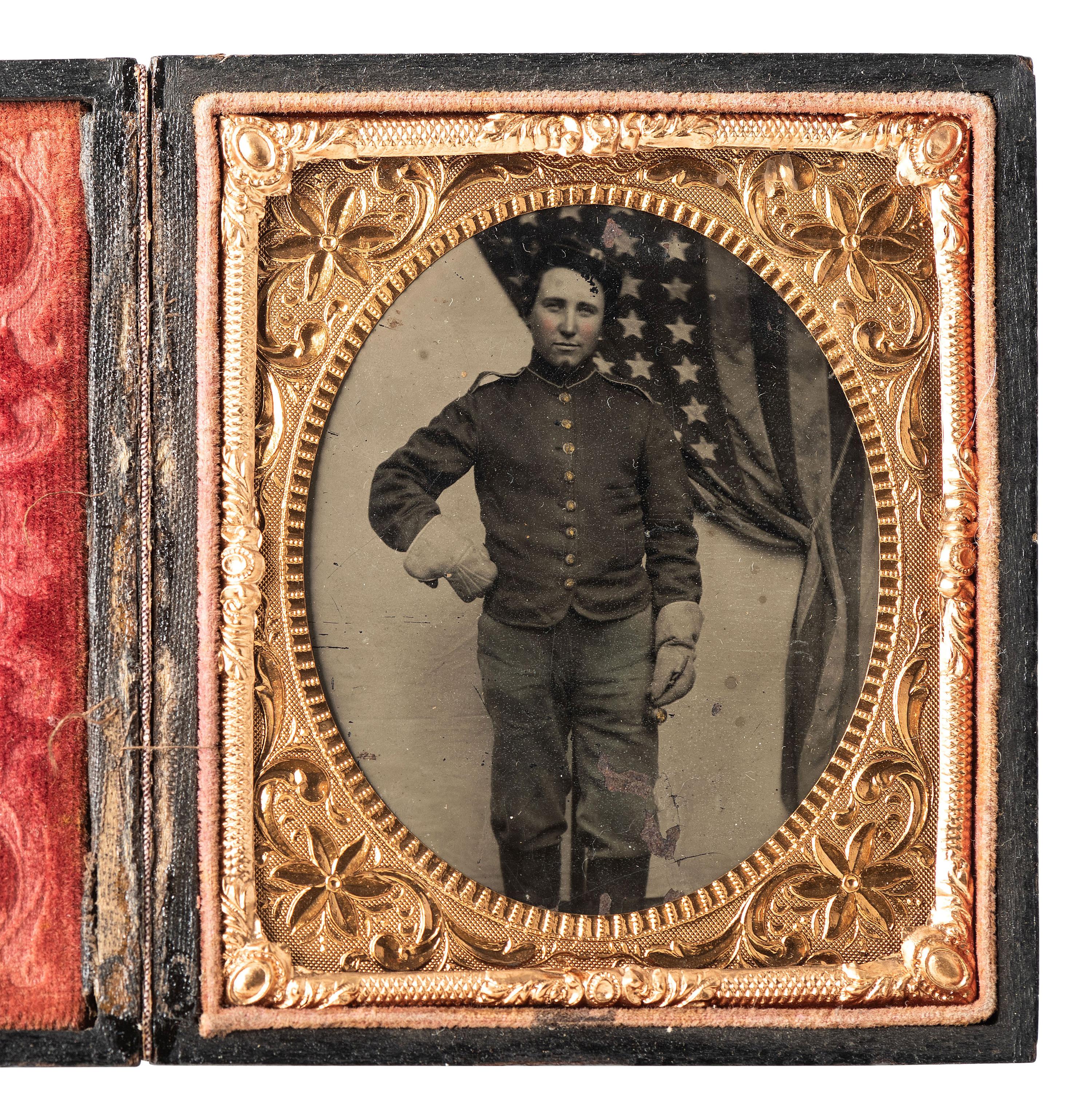 [CIVIL WAR]. Sixth plate tintype of a uniformed soldier standing before a large American flag.