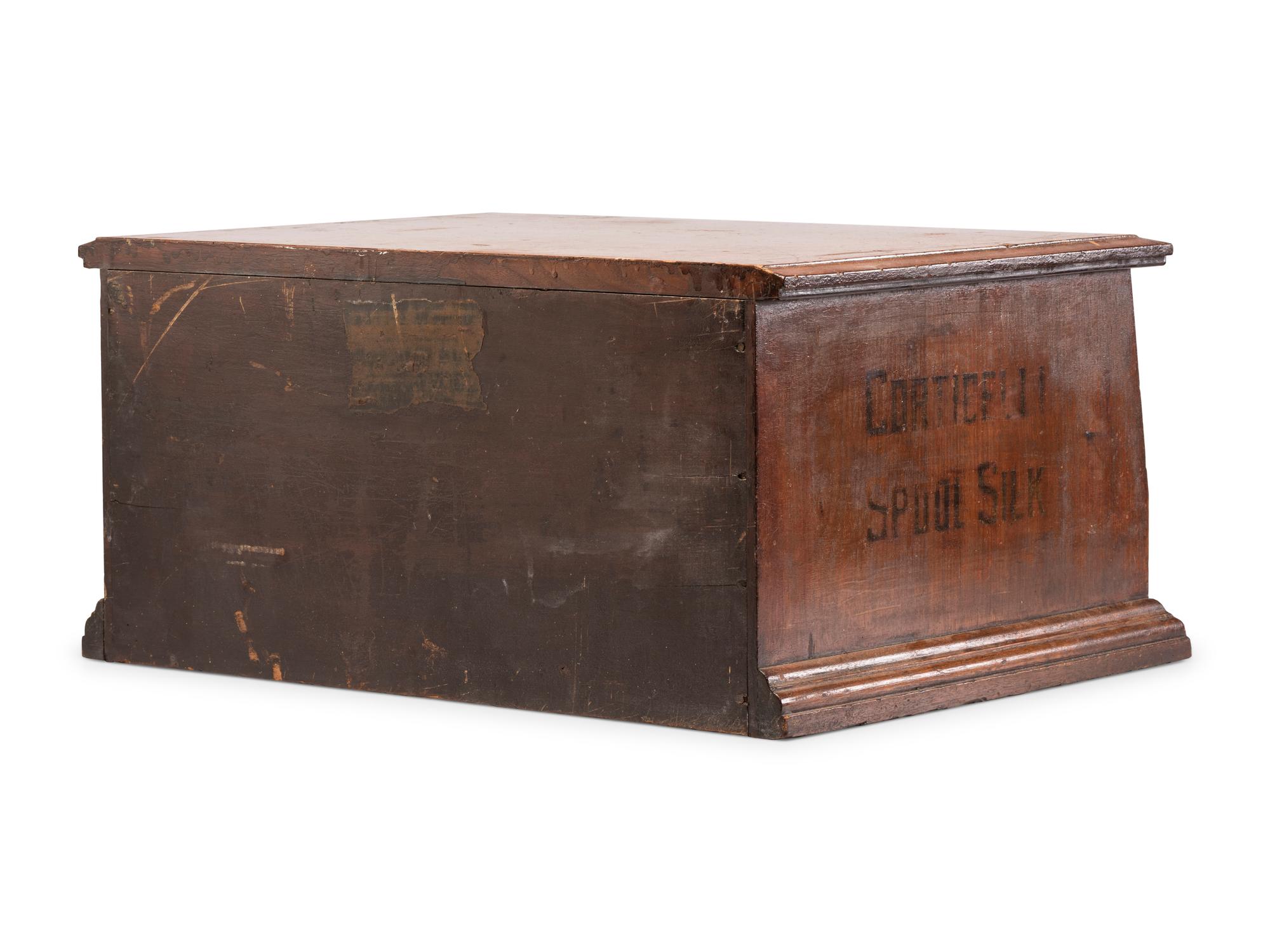 A Corticelli Spool Silk Stenciled Tabletop Spool Cabinet