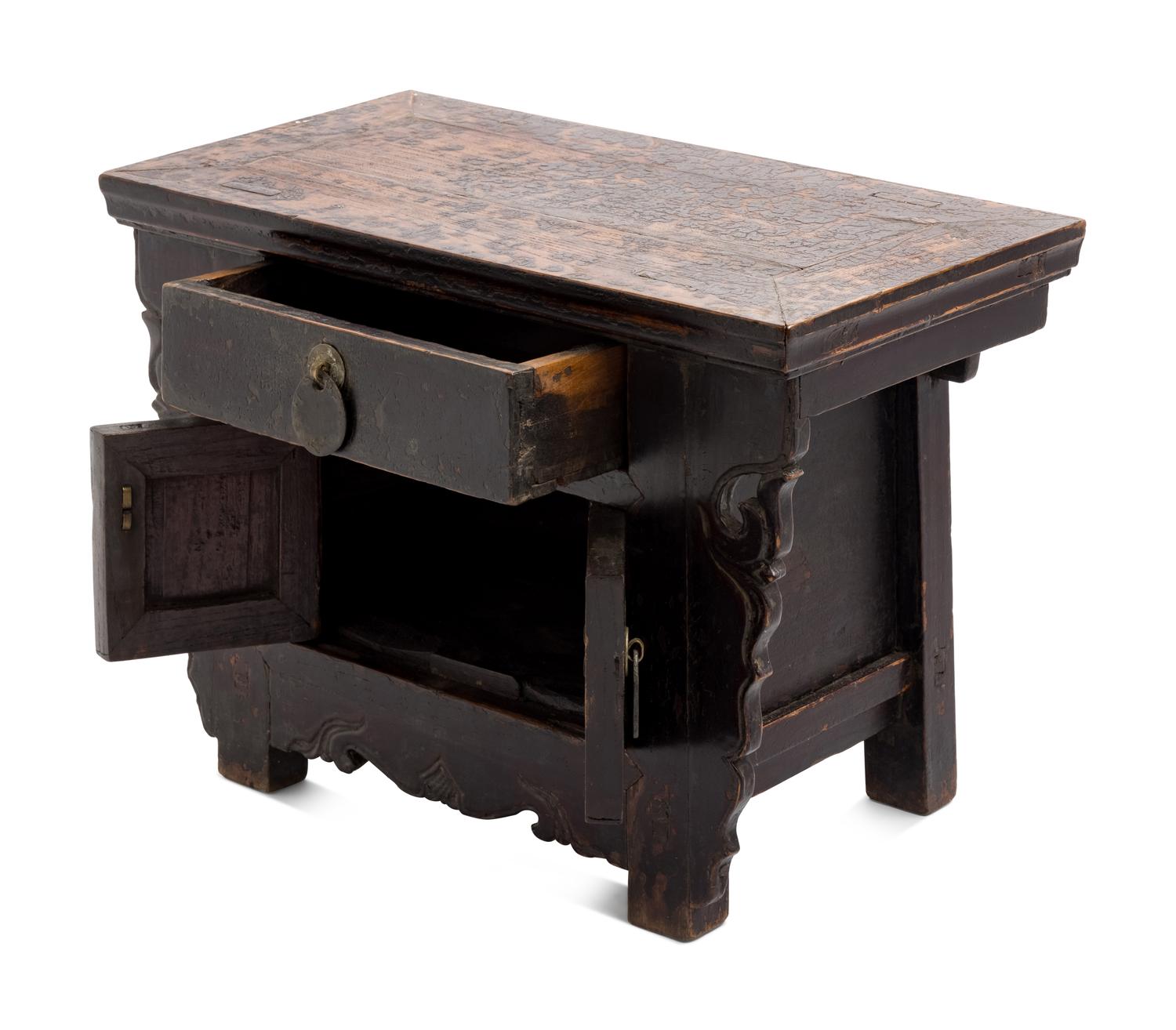 A Chinese Carved and Black Painted Wood Diminutive Chest