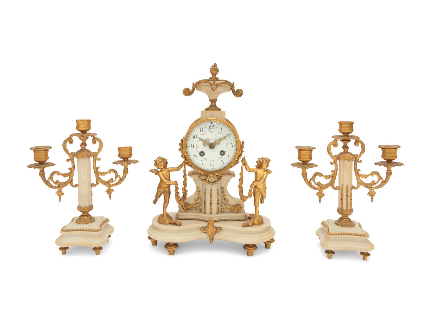 A Louis XVI Style Gilt Bronze and Marble Clock Garniture