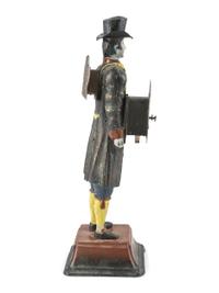 A Painted Cast-Iron 'Clock Peddler' Figural Desk Clock