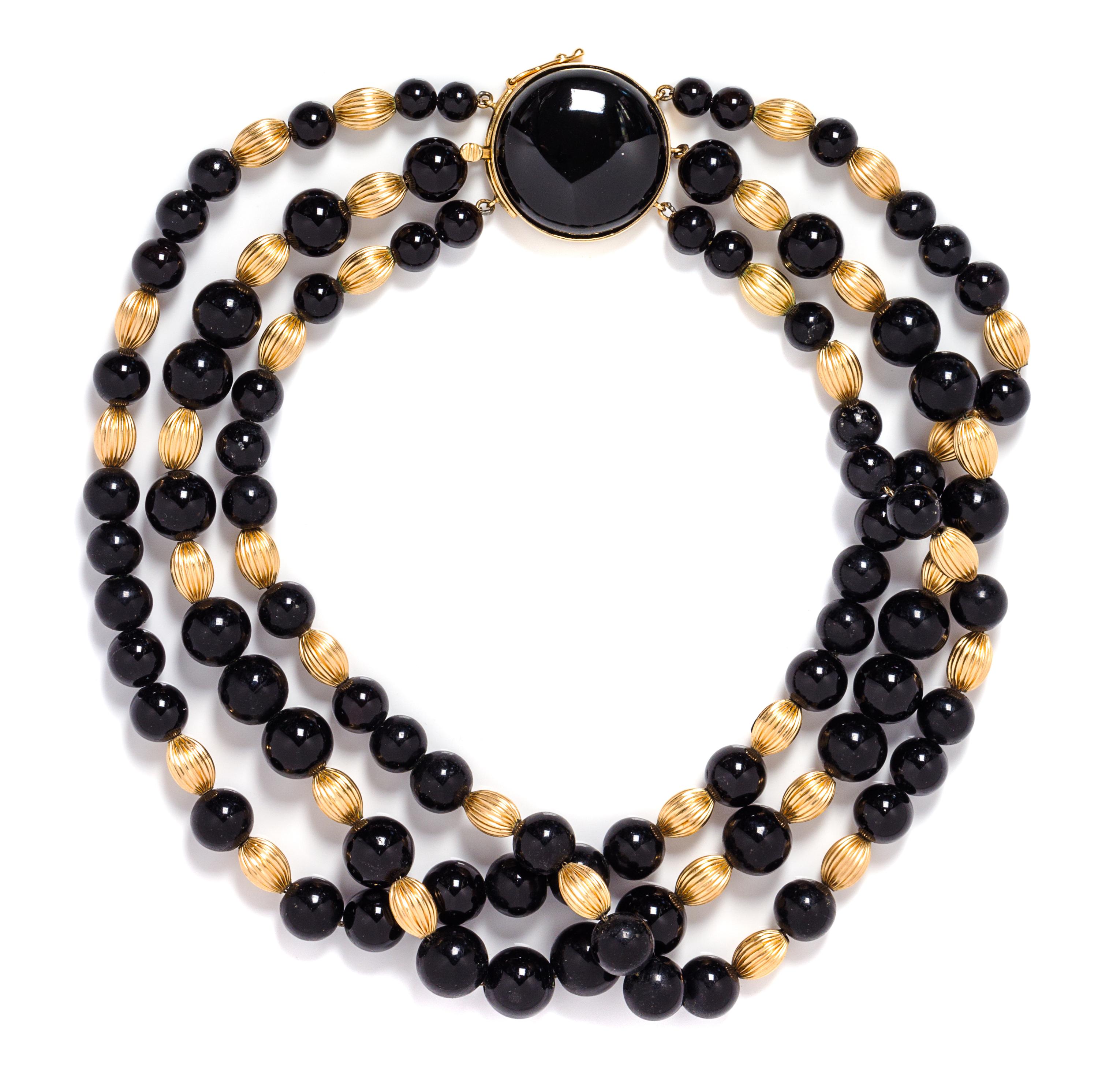A Triple Strand Yellow Gold and Onyx Bead Necklace, 63.30 dwts.