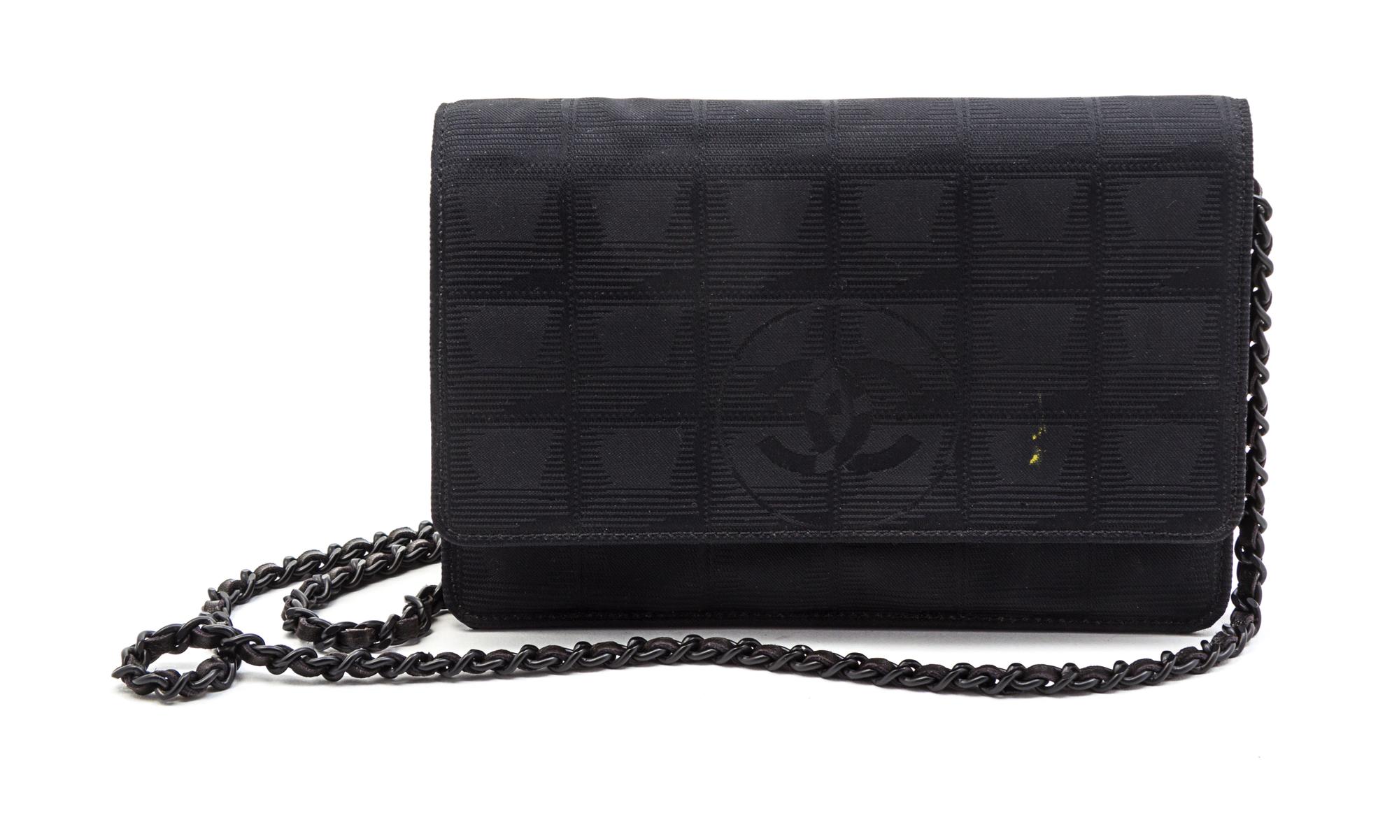A Chanel Black Canvas Travel Line Wallet on a Chain, 7 x 5 1/2 x 1 inches.