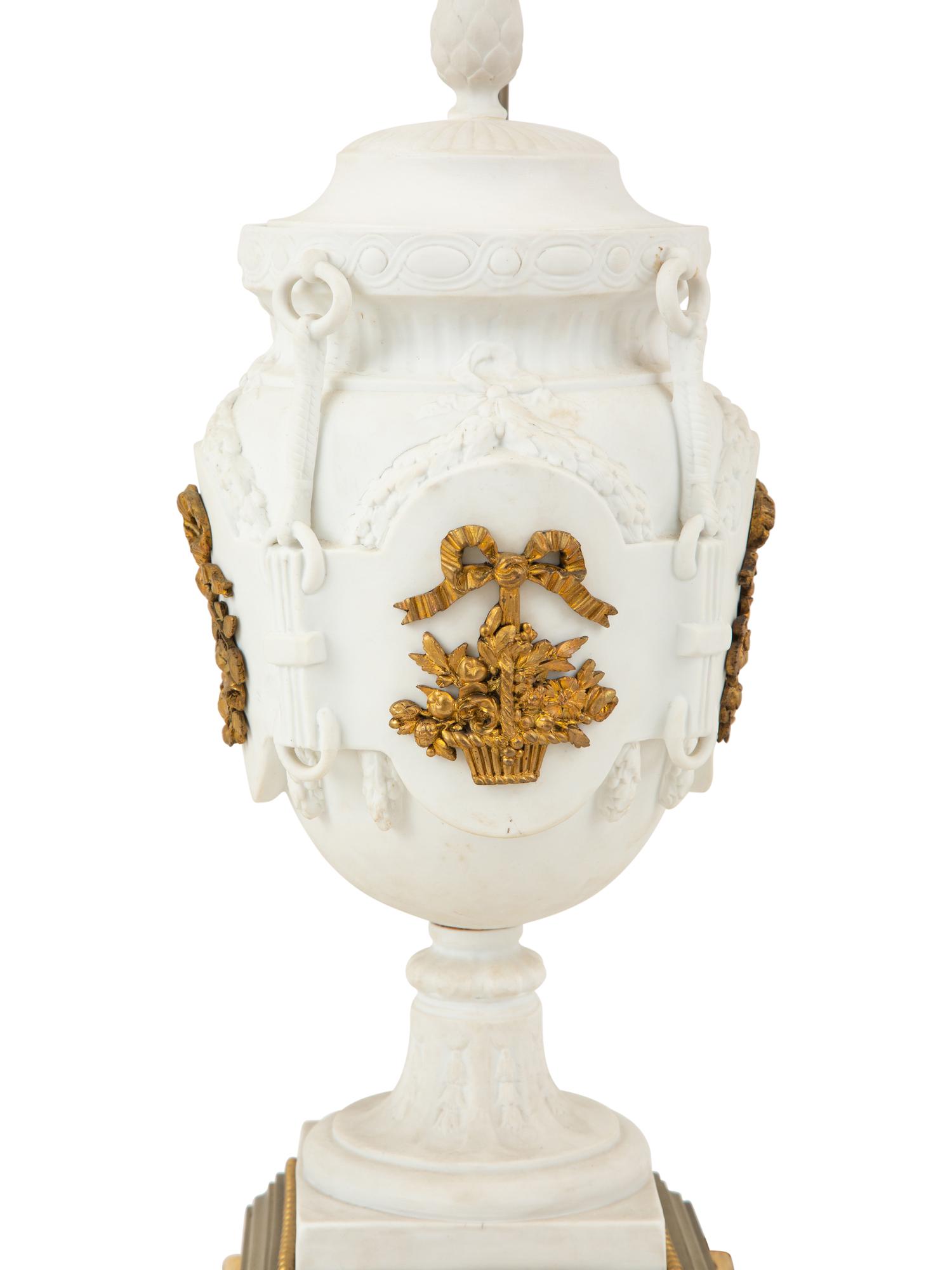 A Pair of Continental Bisque Porcelain Urns with Gilt Metal Mounts