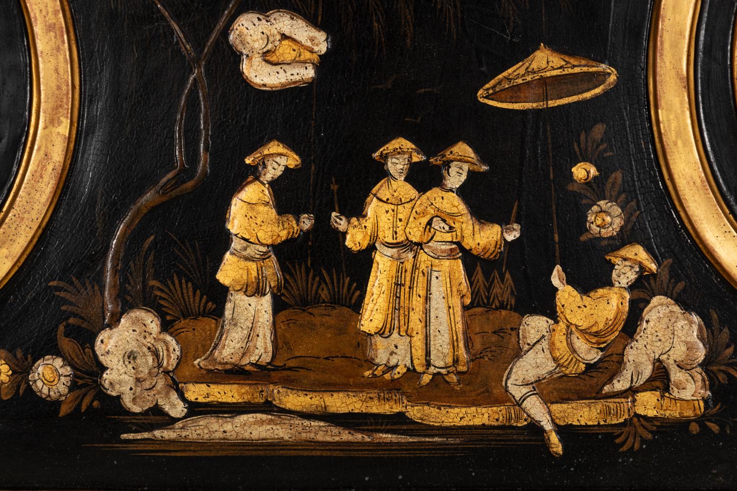 A Régence Style Chinoiserie Ebonized and Giltwood Mirror