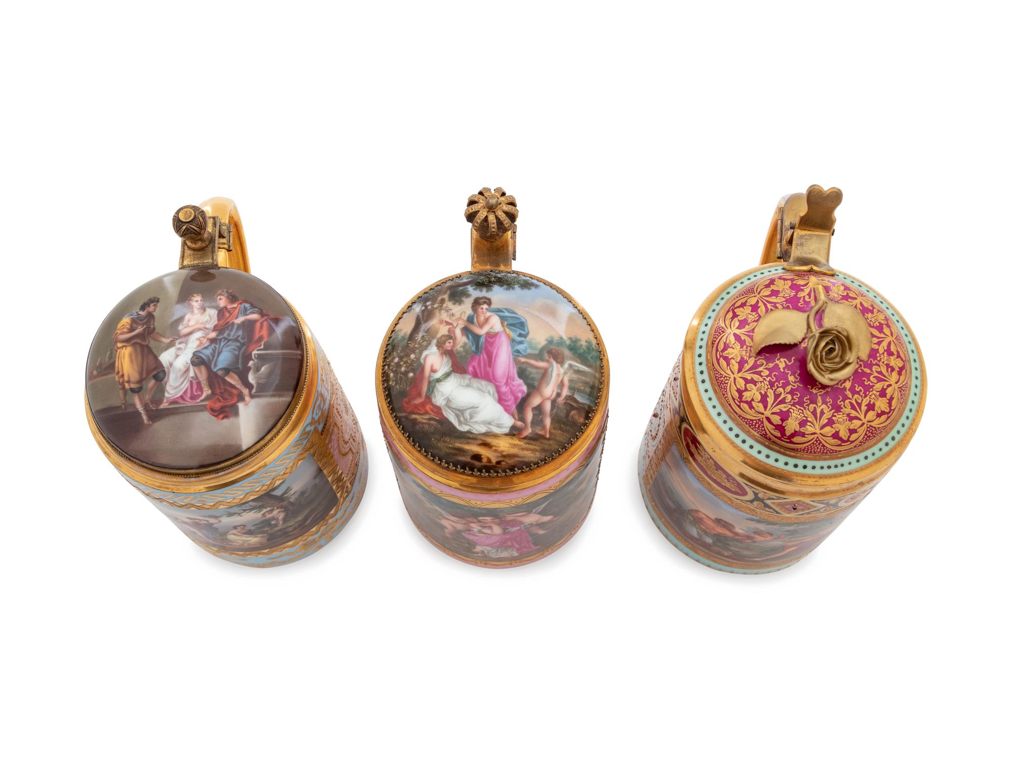 Three Vienna Painted and Parcel Gilt Porcelain Tankards