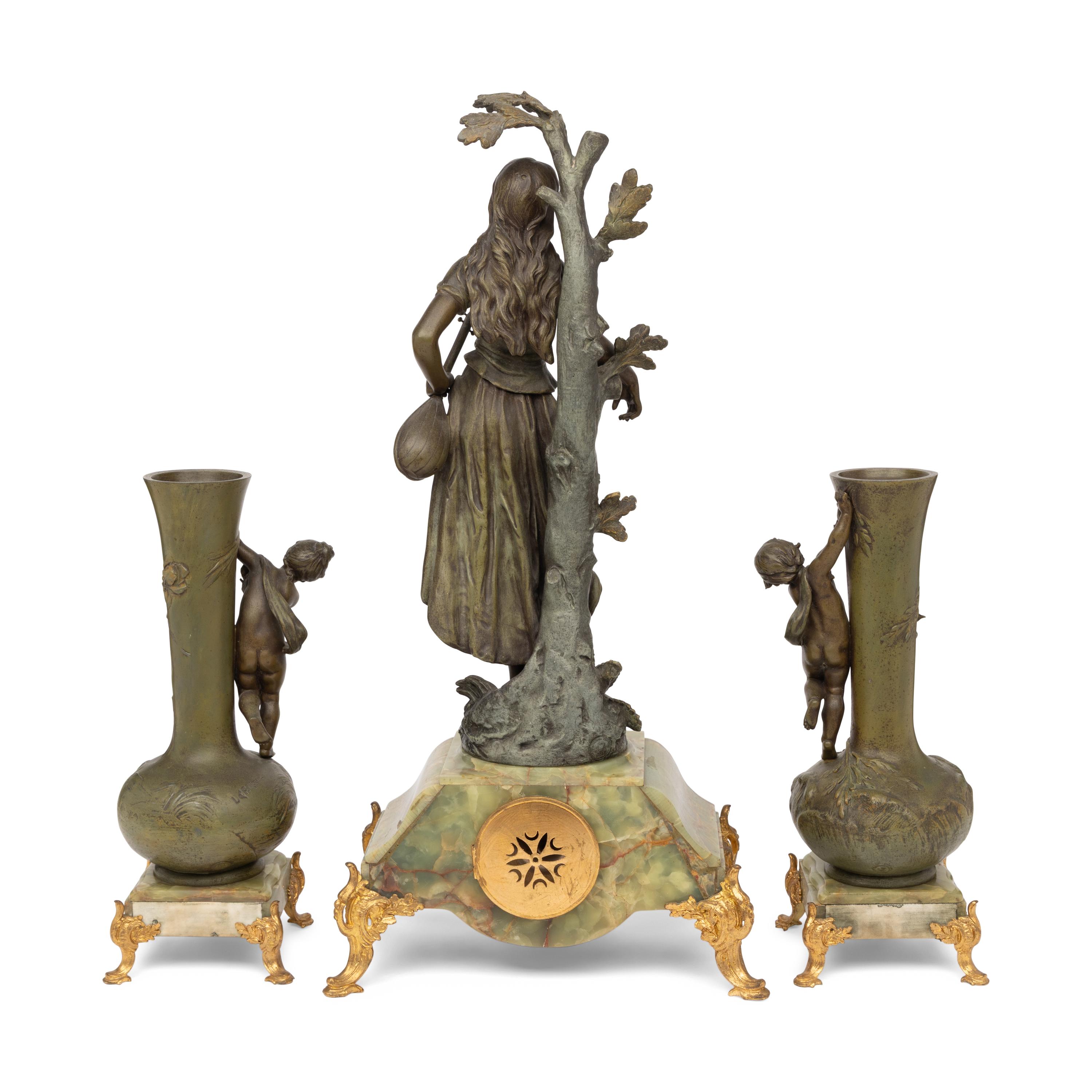 A French Patinated Cast Metal and Onyx Clock Garniture