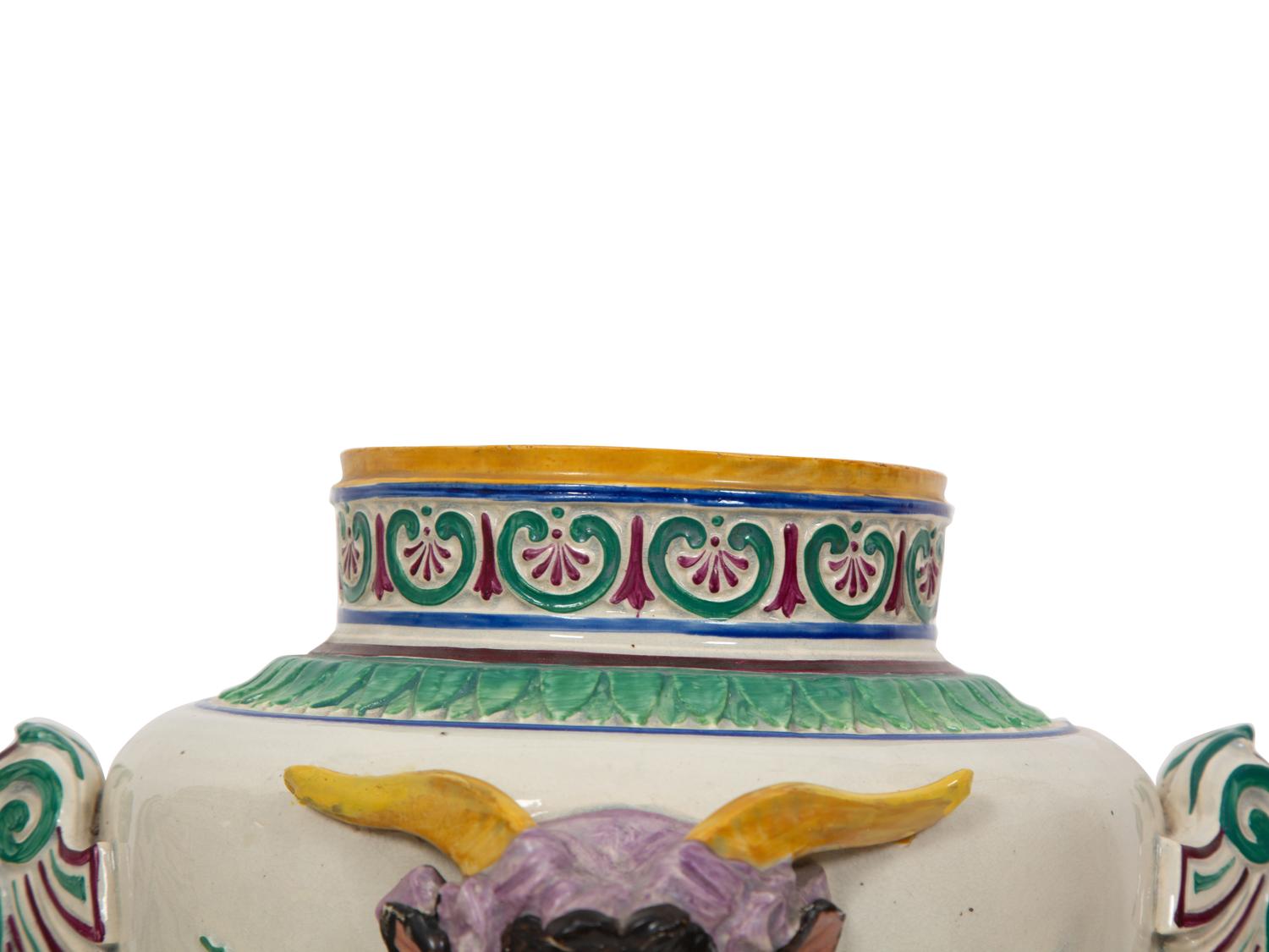 A Pair of Italian Glazed Ceramic Urns Decorated with Horned Masks and Paw Feet