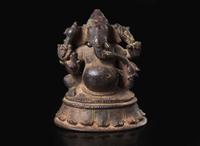 A small South Indian bronze figure of Ganesha seated, 16th/17th century or earlier 南印度象頭神坐像 十六或十七世紀初