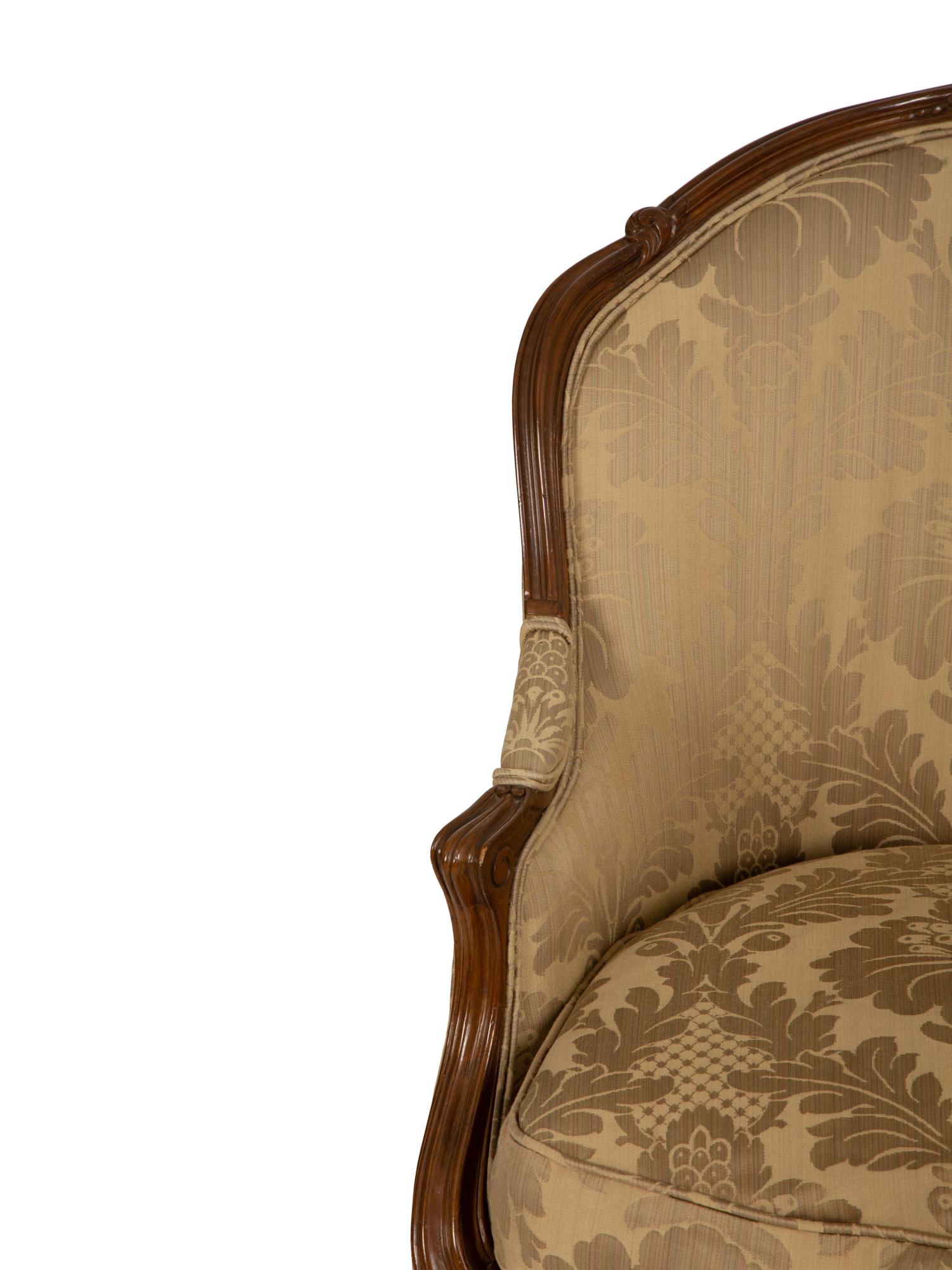 A Louis XV Style Carved Walnut Bergère