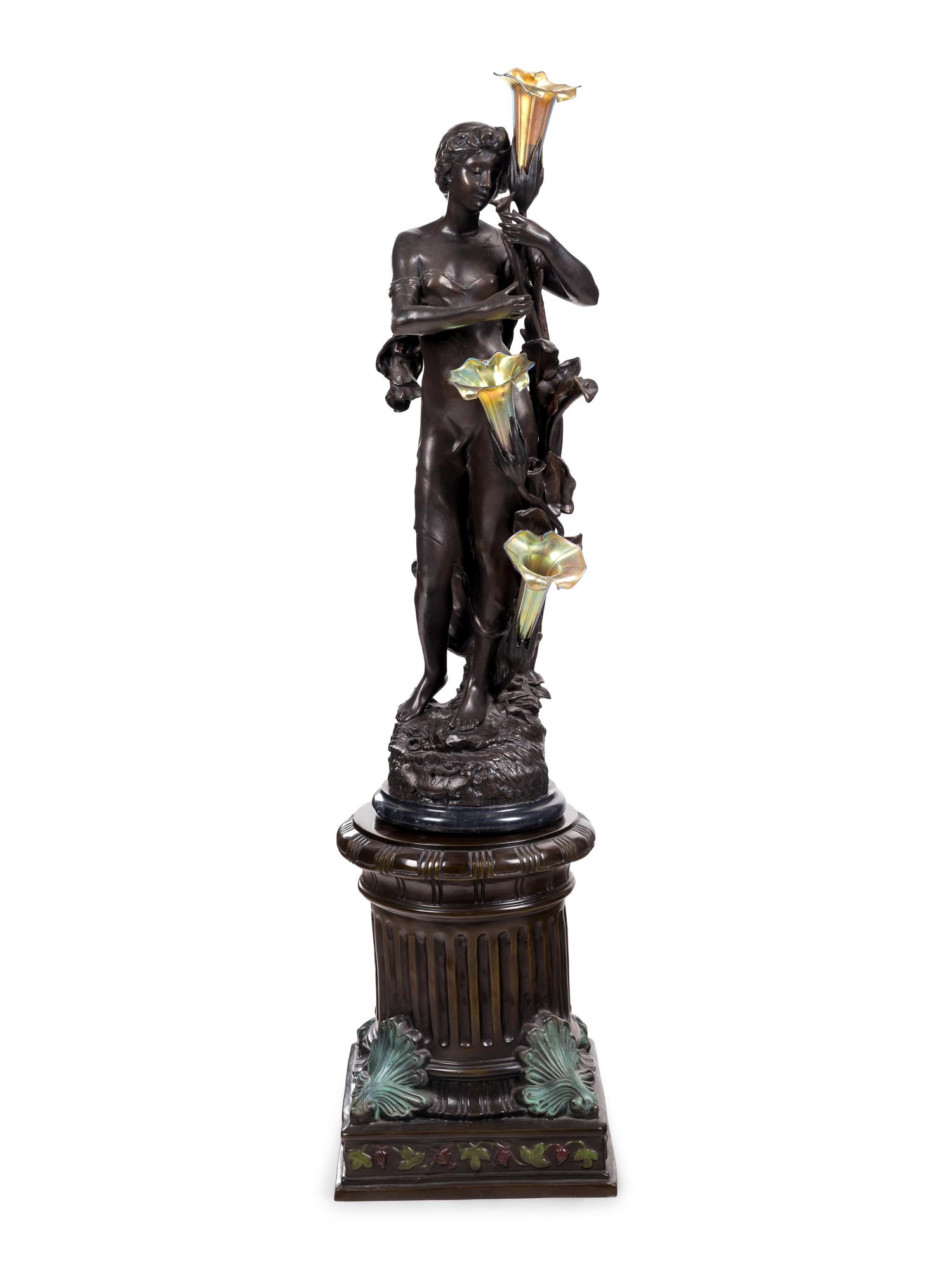 A Patinated Bronze Figural Lamp with Iridescent Glass Shades after Hippolyte François Moreau (French, 1832-1927)
