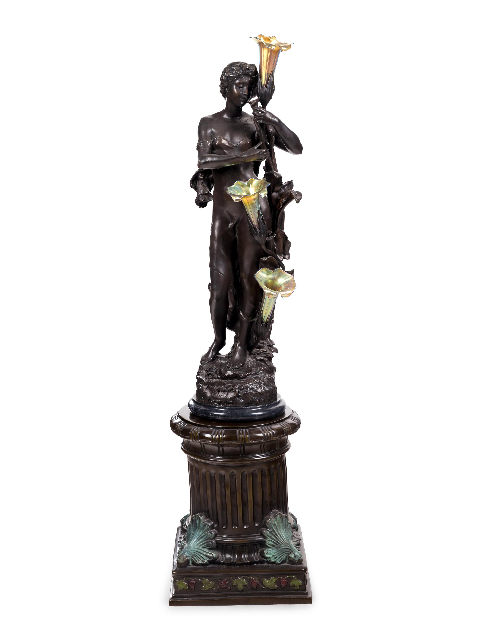 A Patinated Bronze Figural Lamp with Iridescent Glass Shades after Hippolyte François Moreau (French, 1832-1927)