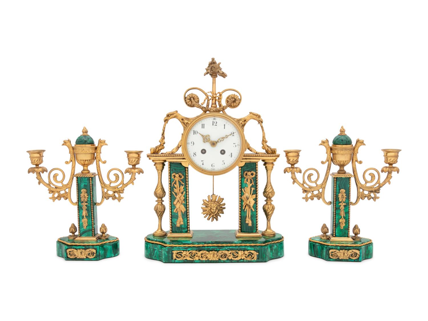 A Gilt Bronze and Malachite Veneered Clock Garniture