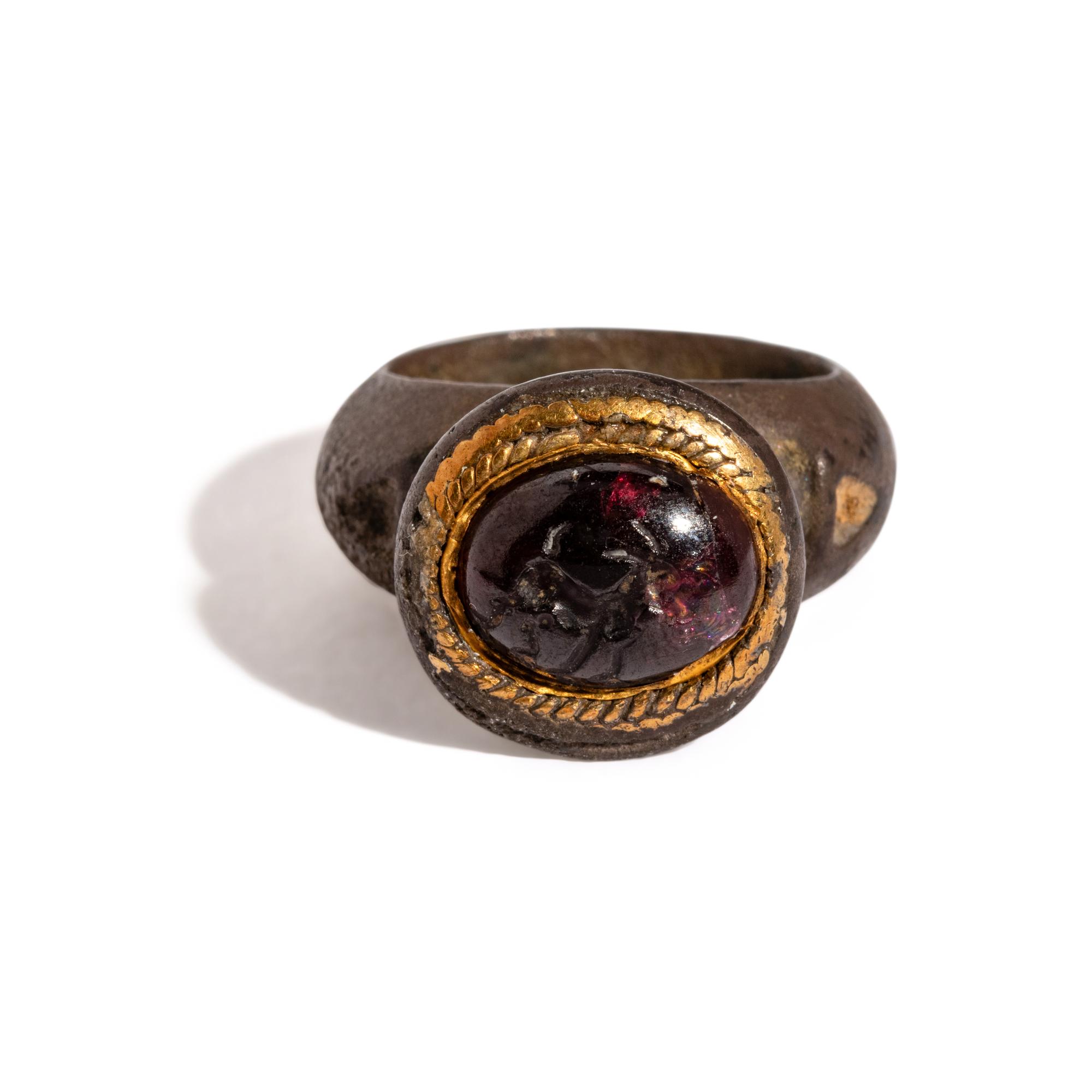 A Roman Gilt-Silver and Garnet Finger Ring with a Ram