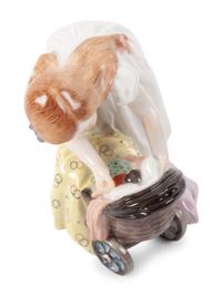 A Meissen Porcelain Figure of a Girl with a Doll Stroller, by Konrad Hentschel