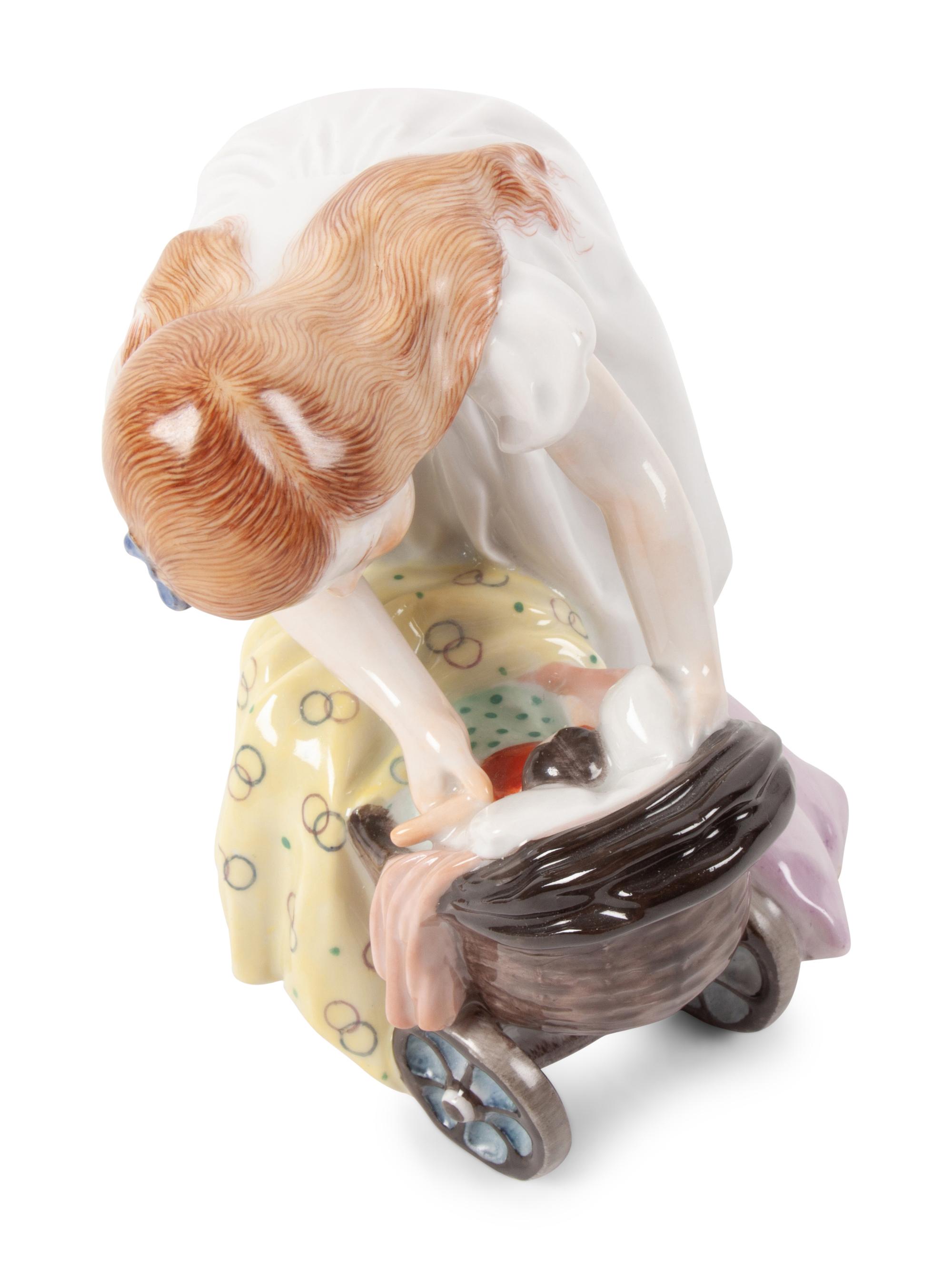 A Meissen Porcelain Figure of a Girl with a Doll Stroller, by Konrad Hentschel