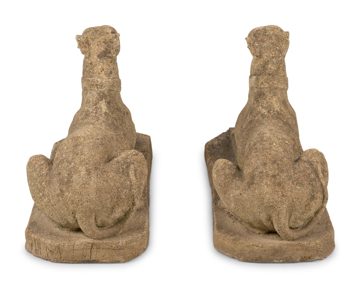 A Pair of Cast Stone Models of Recumbent Dogs