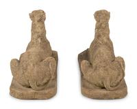 A Pair of Cast Stone Models of Recumbent Dogs