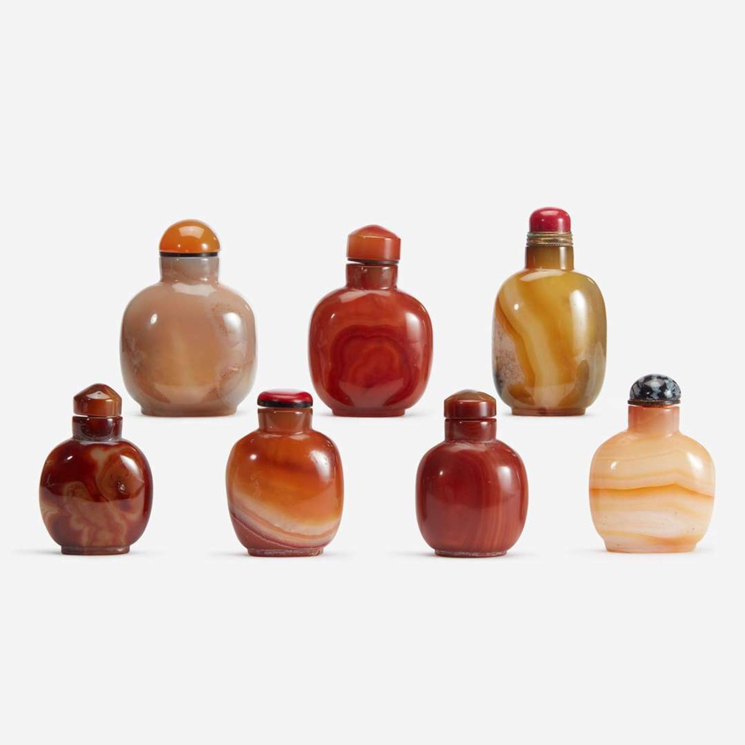An assorted group of seven Chinese carnelian and agate snuff bottles