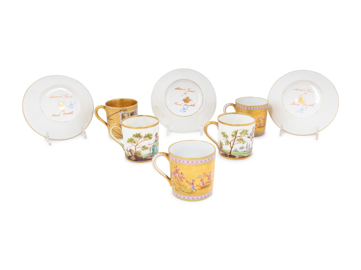A Group of French Painted Porcelain Coffee Cups and Saucers