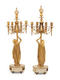 A Louis XVI Style Gilt Bronze and Marble Figural Clock Garniture