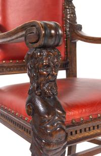A Set of Eight R.J. Horner Carved Oak Man of the Mountain Dining Chairs
