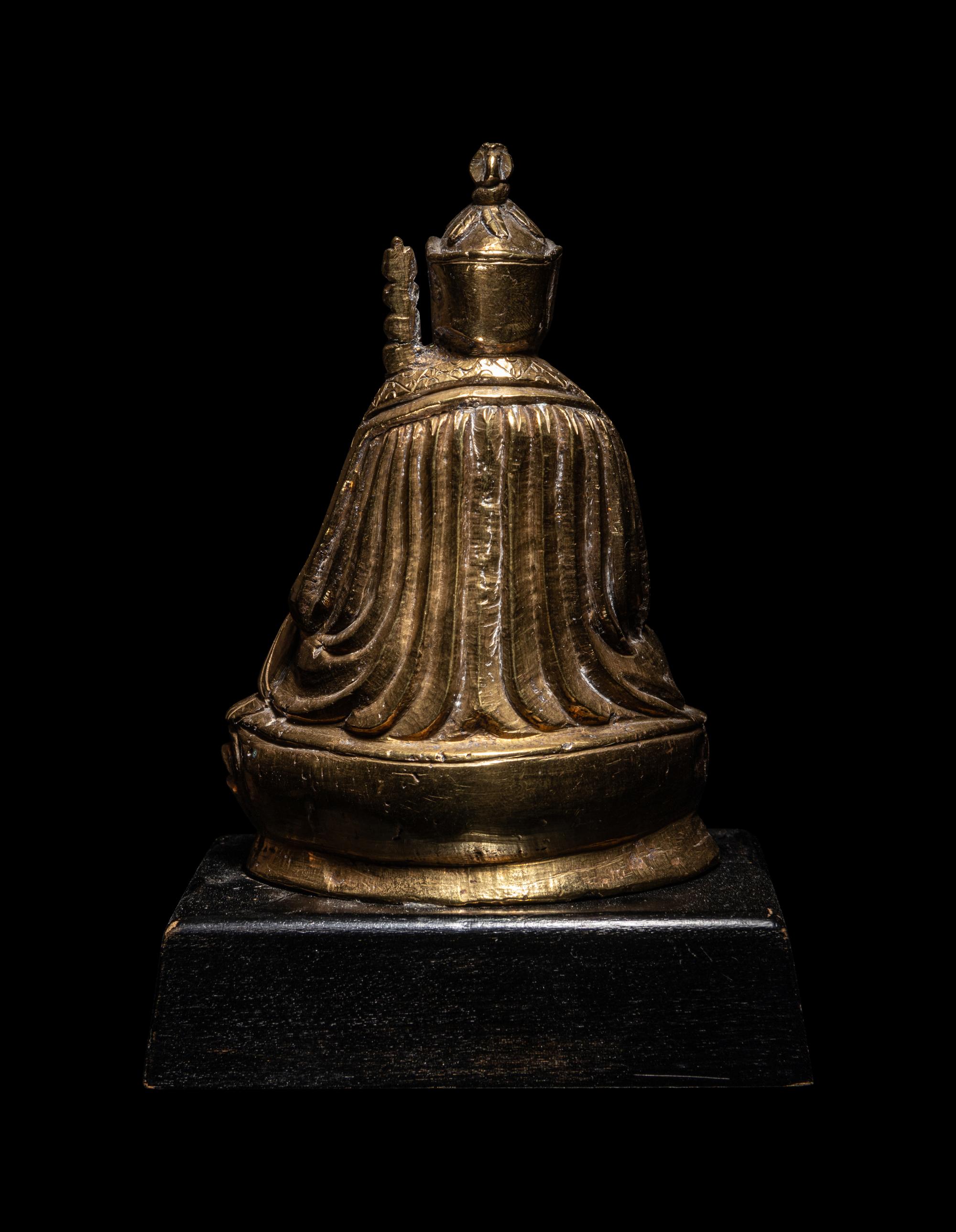 A Tibetan Gilt Bronze Figure of a Priest