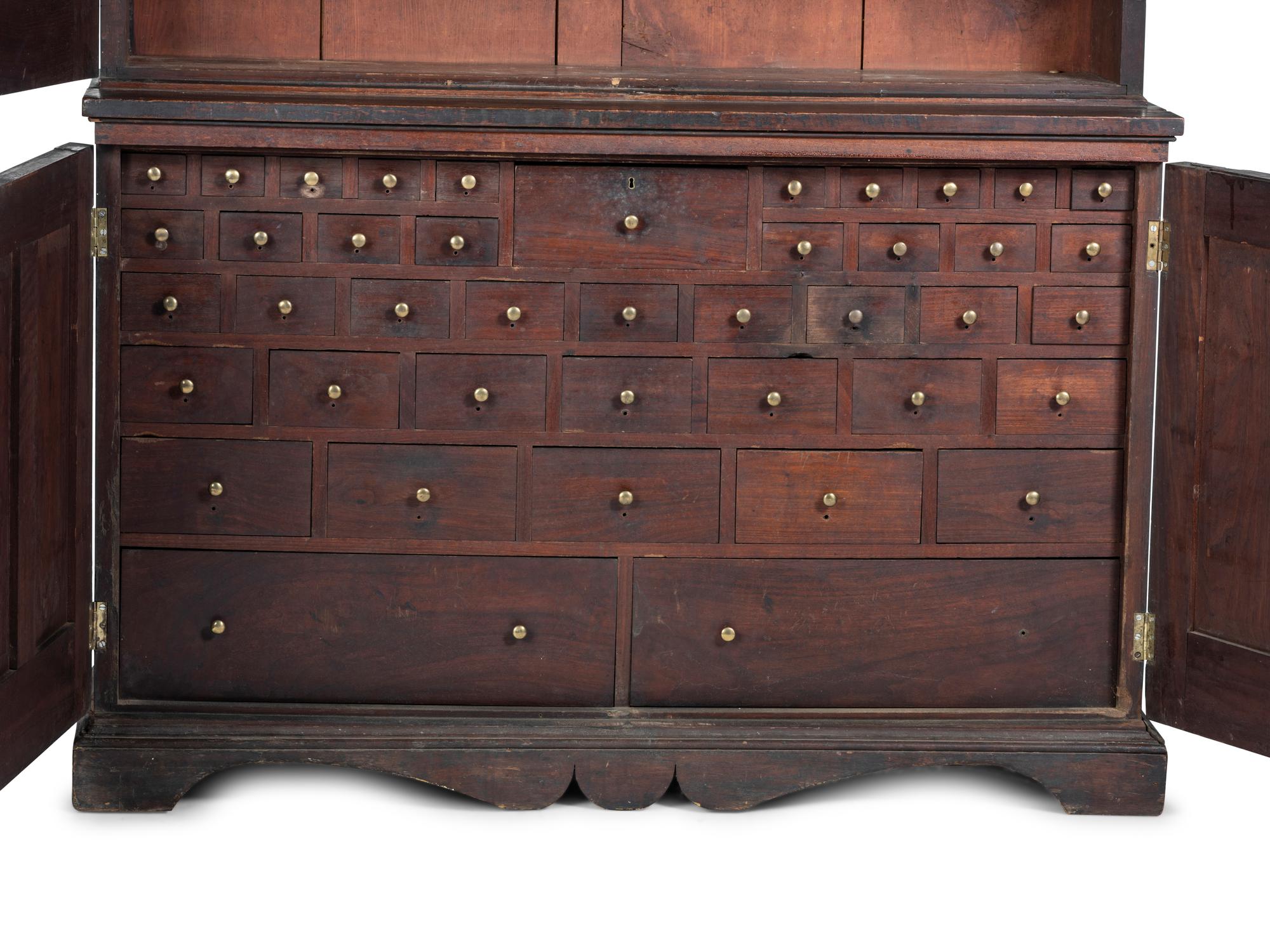 A Chippendale Style Walnut Paneled Step Back Cupboard