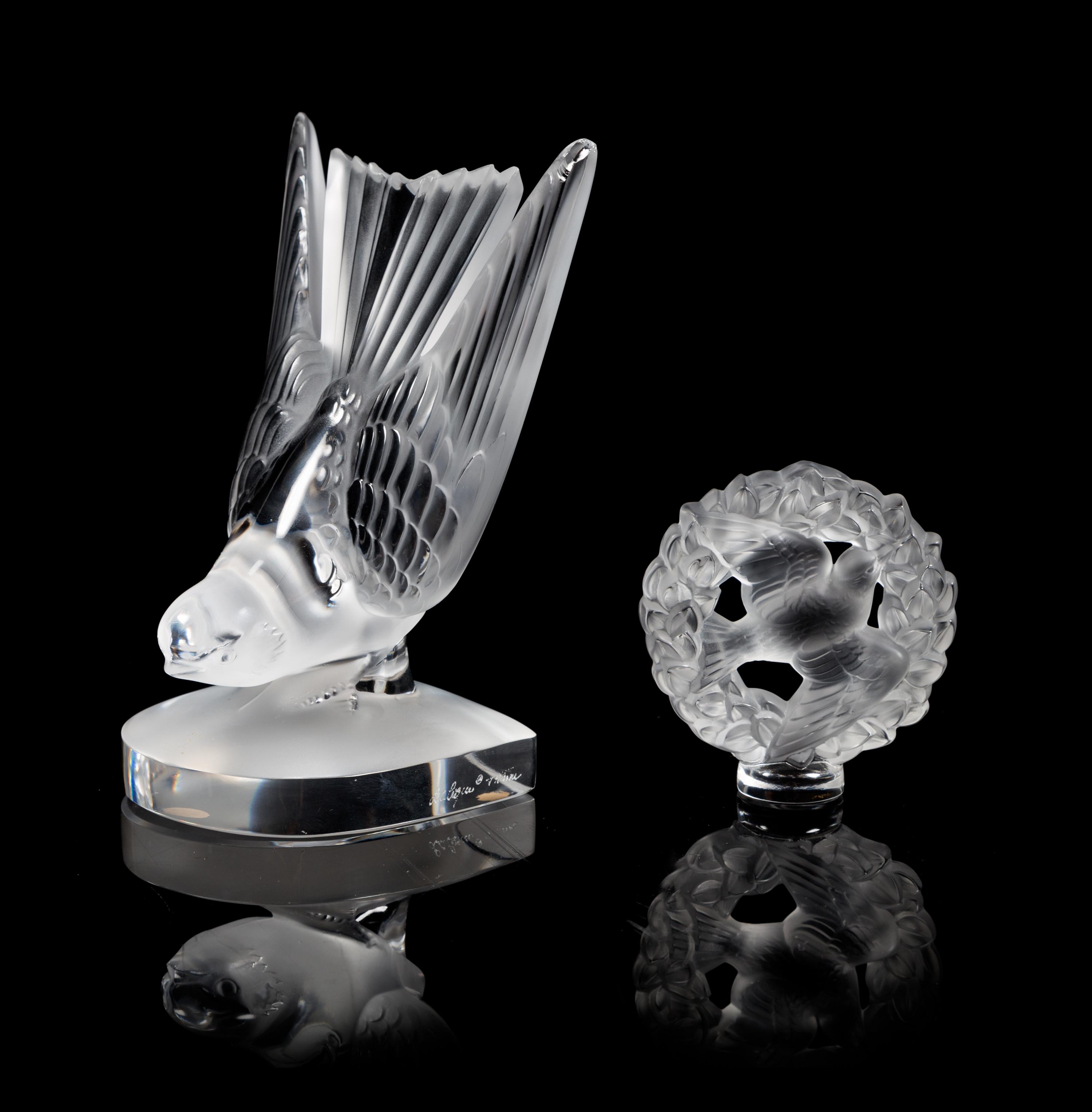 Lalique, a group of two molded and frosted glass figures, comprising a Hirondelles bird motif bookend and a Pax figural ornament