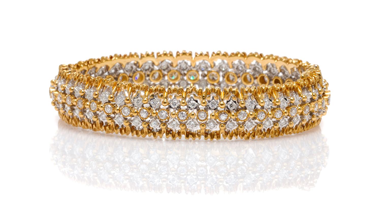 An 18 Karat Two Tone Gold and Diamond Bangle Bracelet, 17.30 dwts.