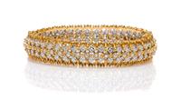 An 18 Karat Two Tone Gold and Diamond Bangle Bracelet, 17.30 dwts.
