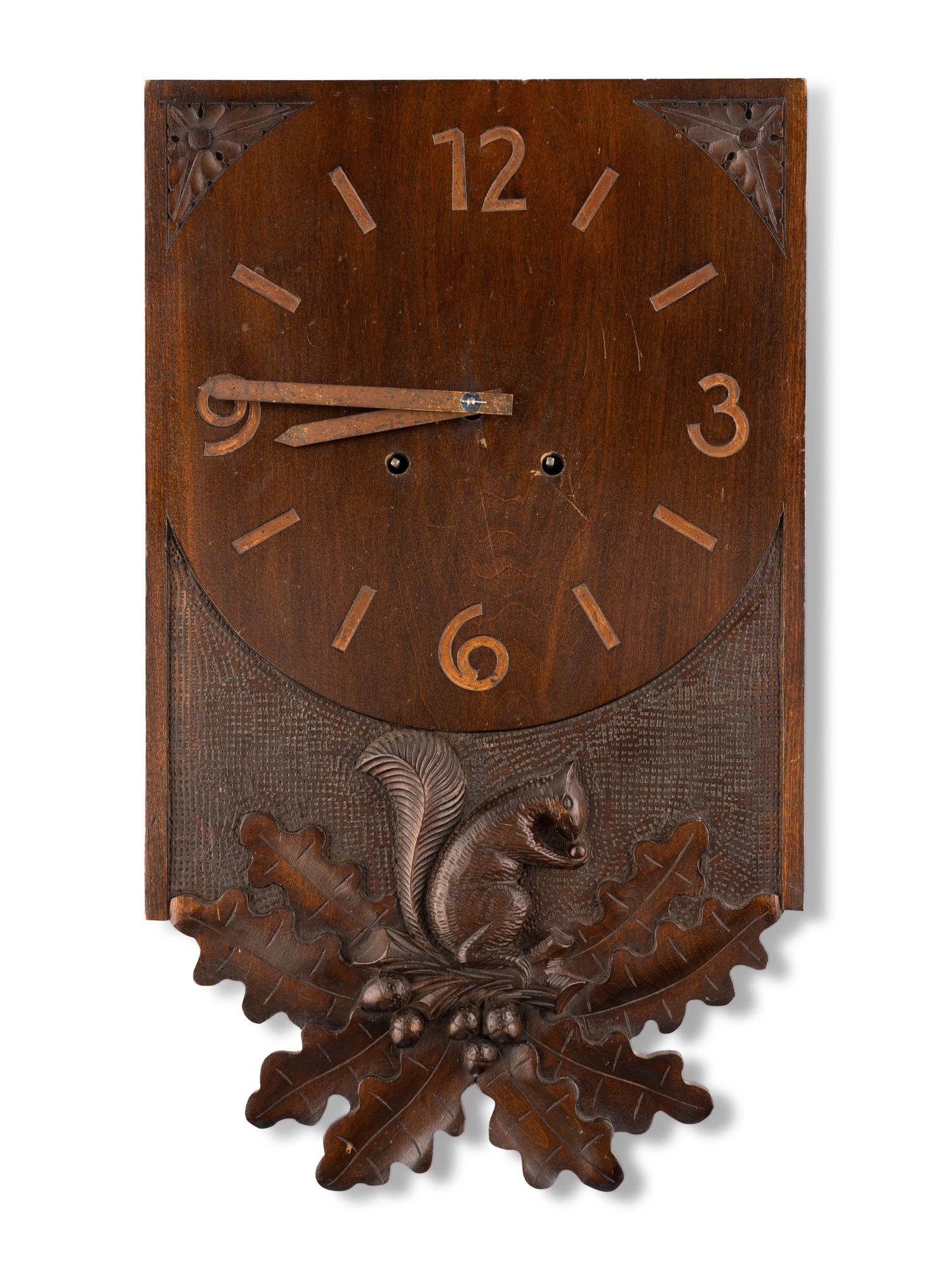 A Swiss "Black Forest" Carved Walnut Wall Clock