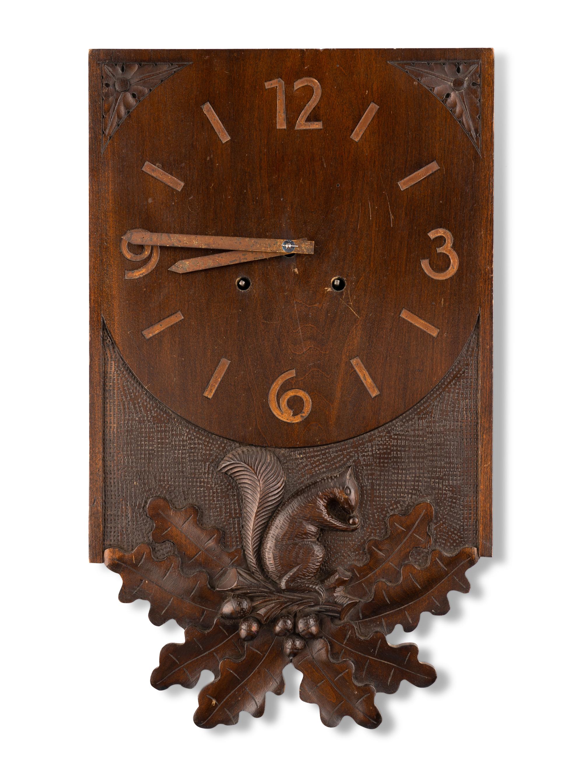 A Swiss "Black Forest" Carved Walnut Wall Clock