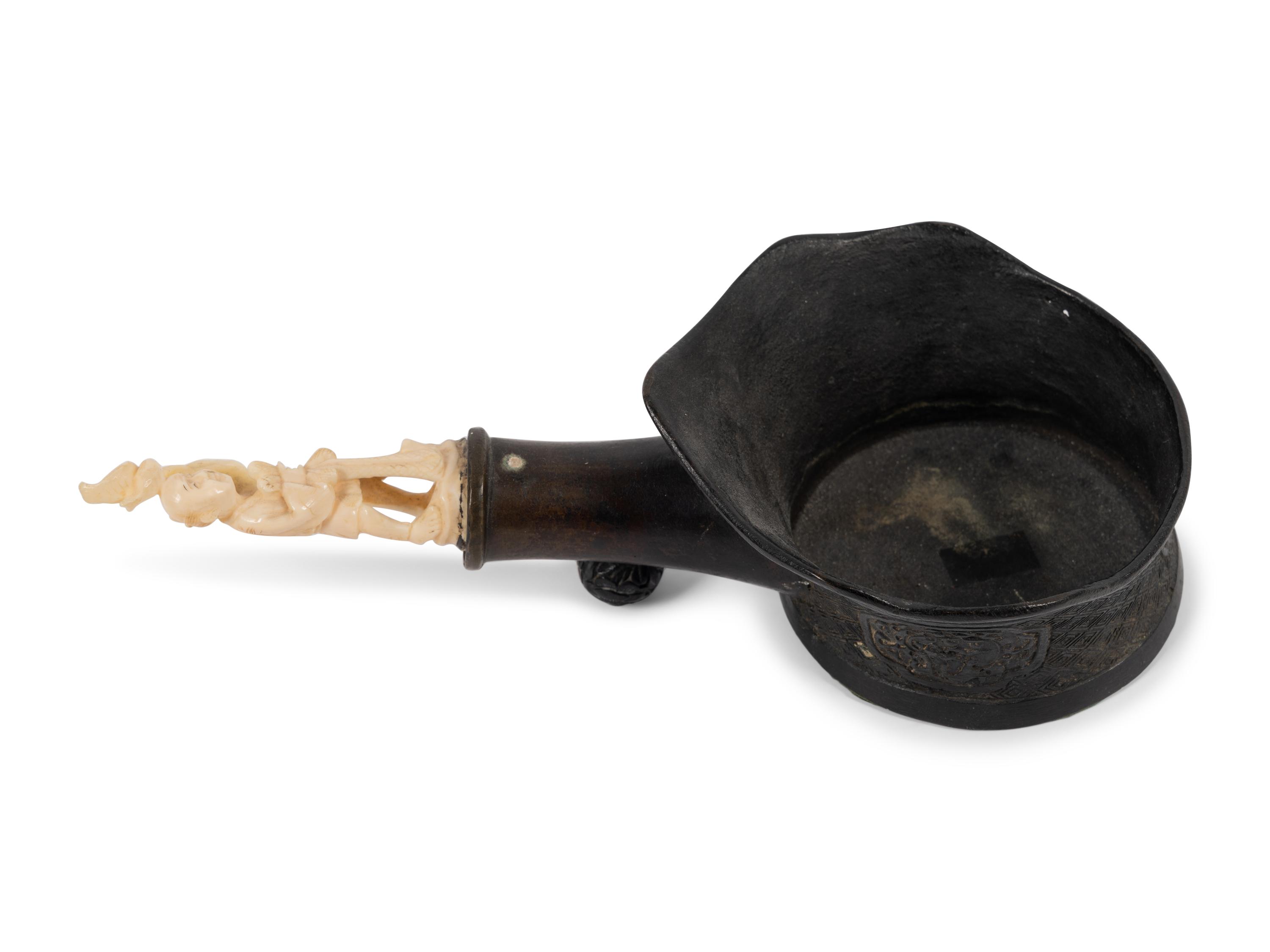 A Chinese Silk Iron with a Figural Handle