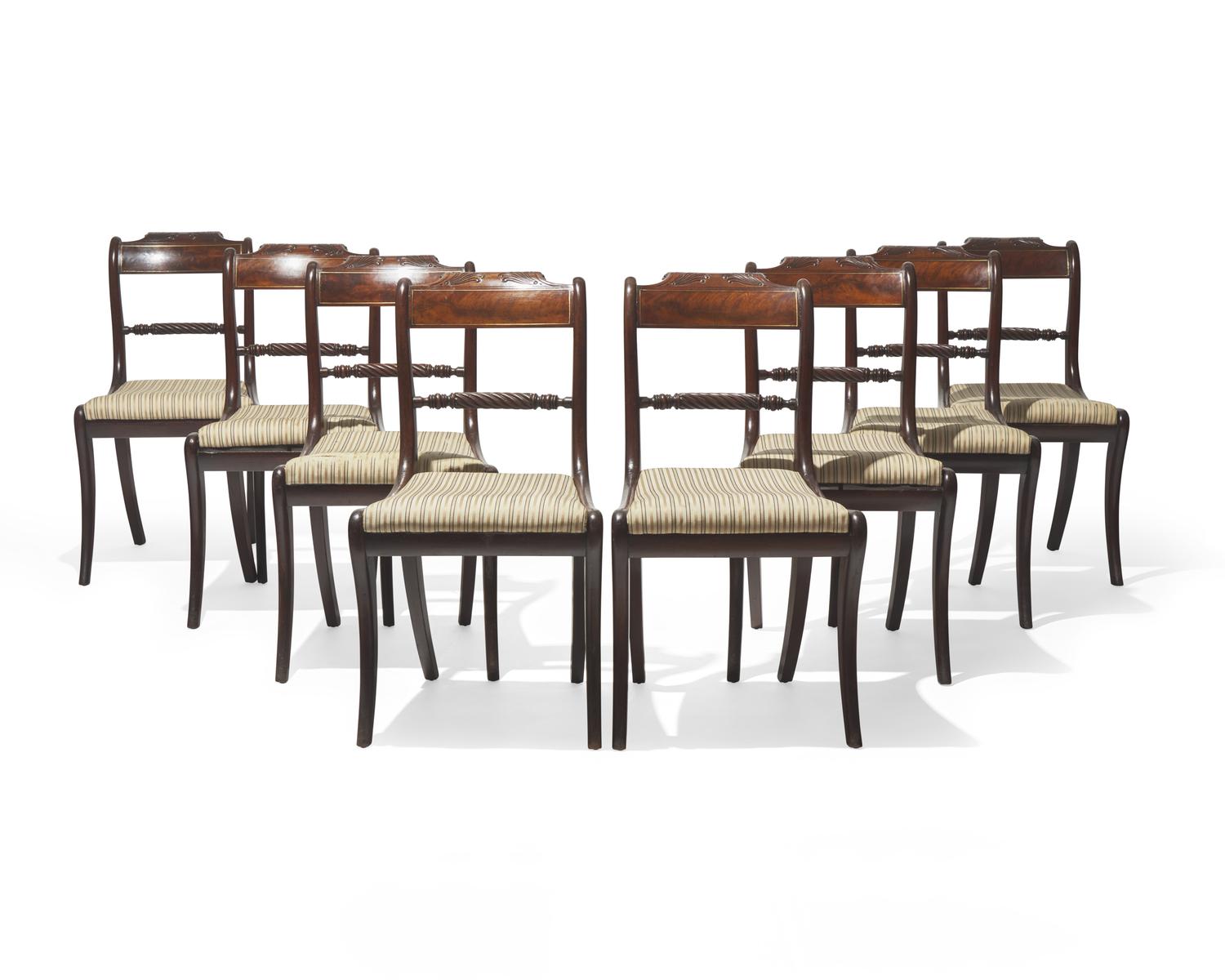 A set of eight Regency brass-inlaid mahogany side chairs, circa 1820